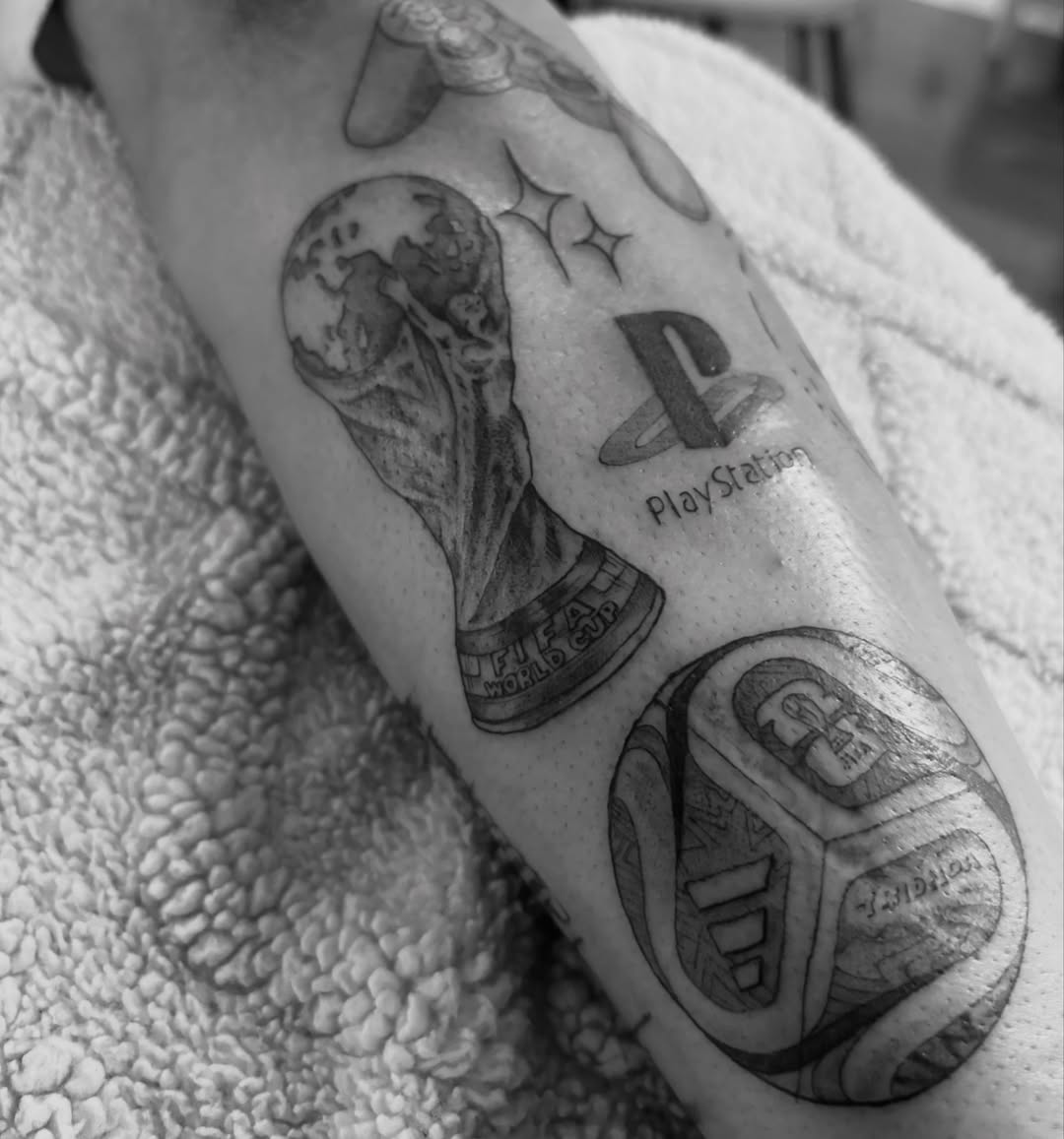 Soccer ball and trophy realism tattoo on the forearm by @secretlinetattoo