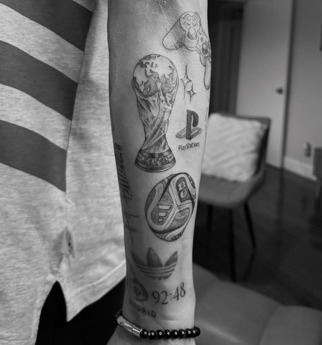 Soccer ball and trophy black and grey tattoo on the forearm by @secretlinetattoo
