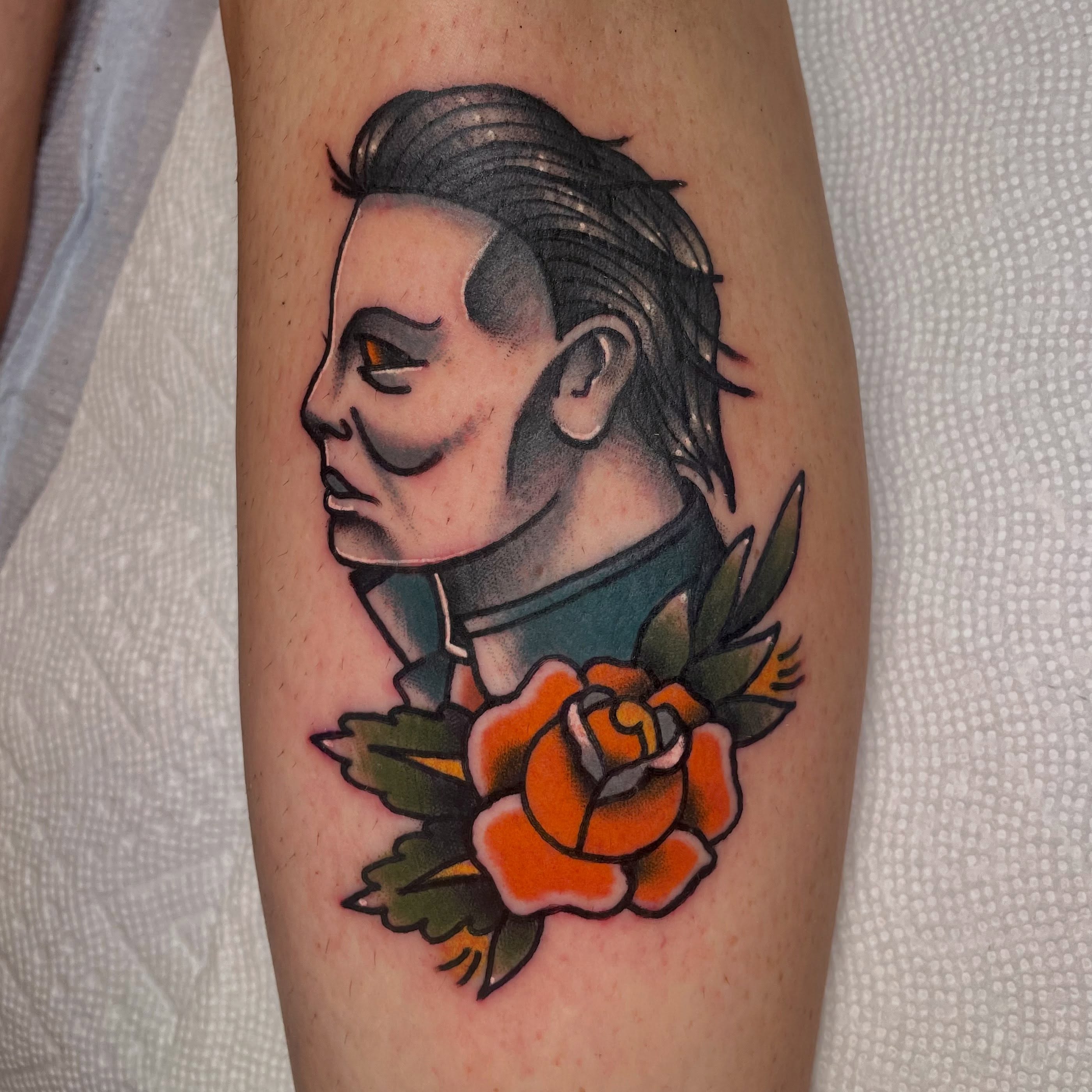 Portrait with rose American traditional tattoo on the forearm by Robert Morrow