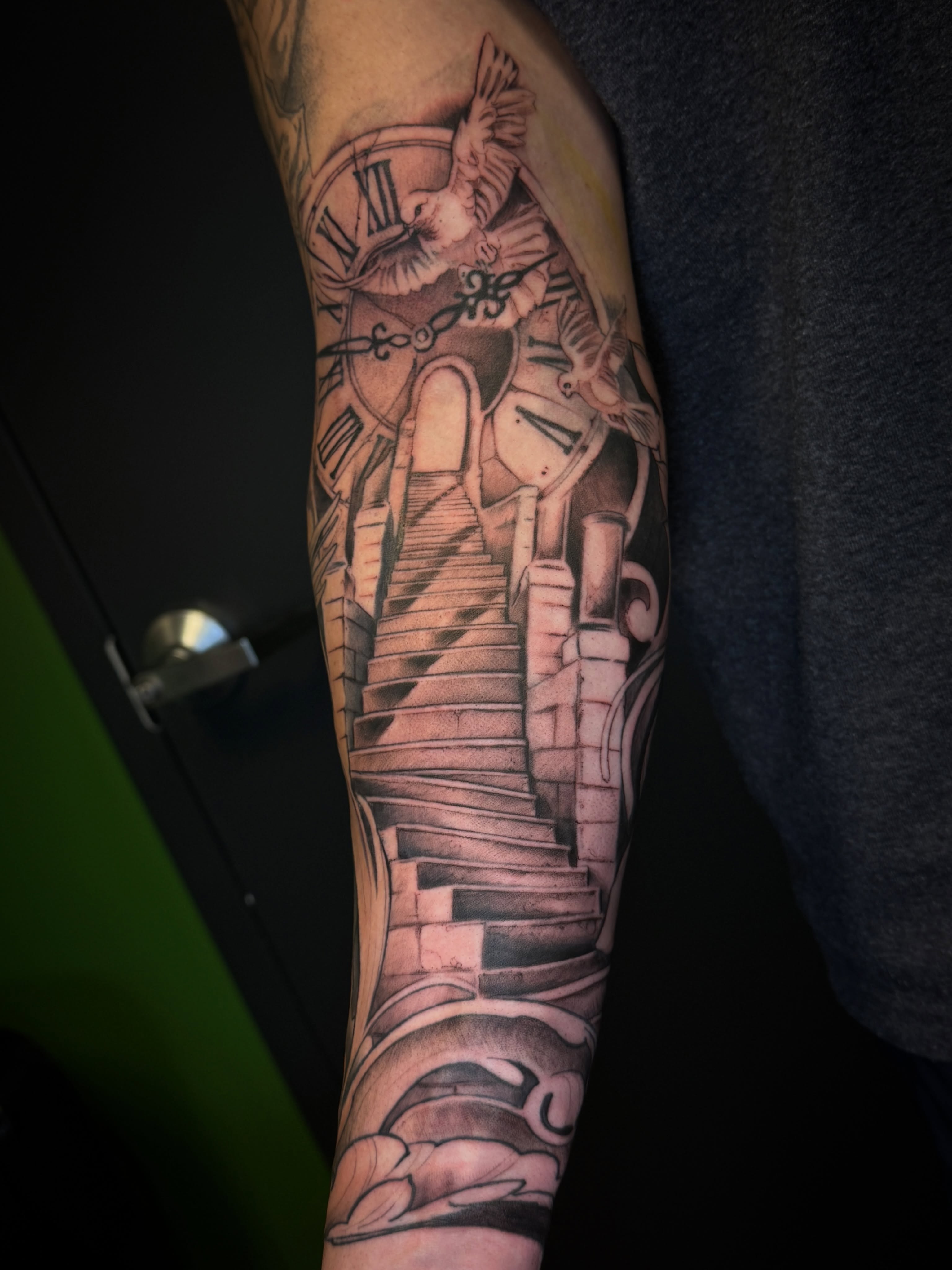 Staircase and clock realism tattoo on the forearm by Joe Hall