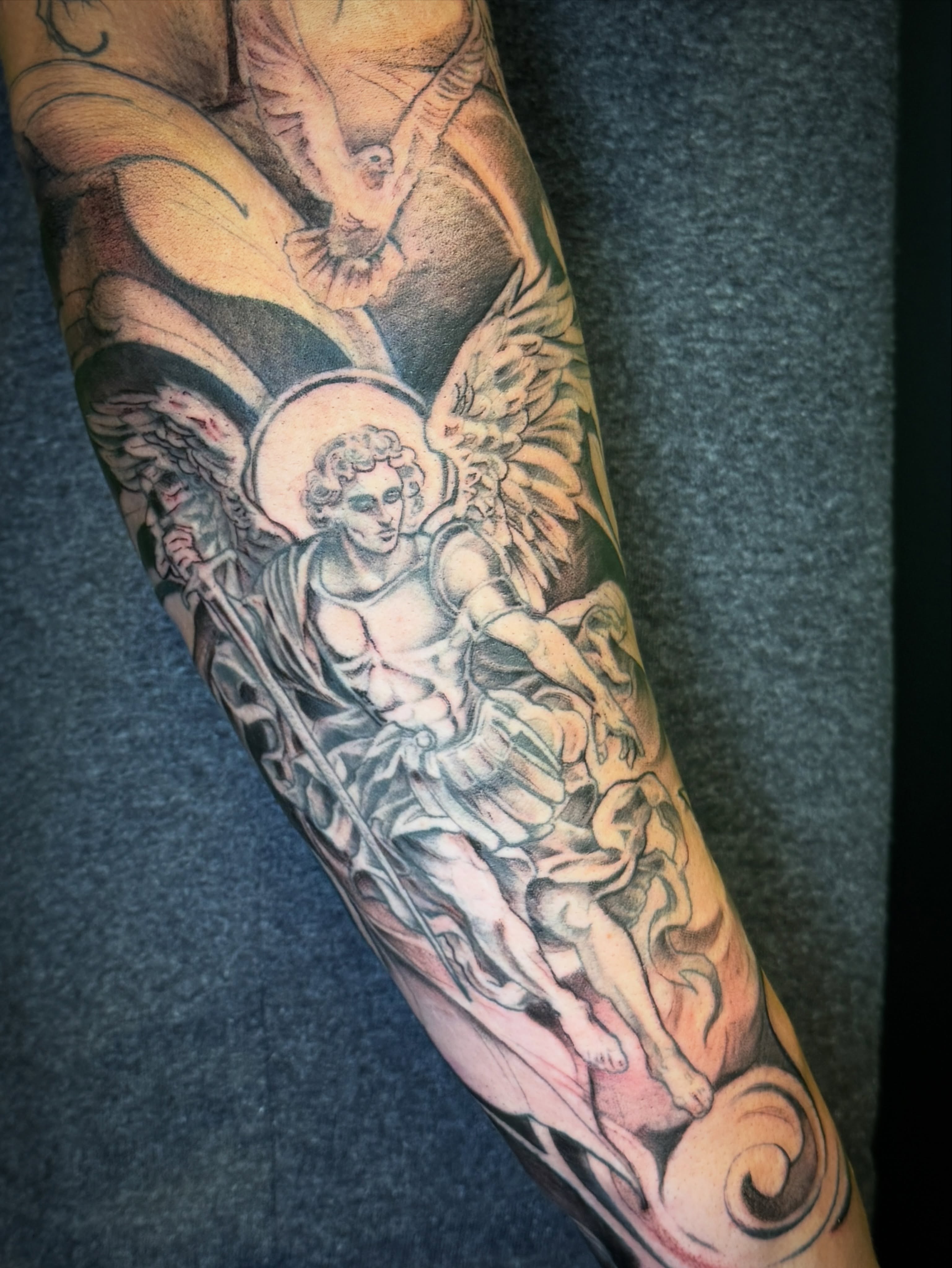 Angel with sword American traditional tattoo on the forearm by Joe Hall