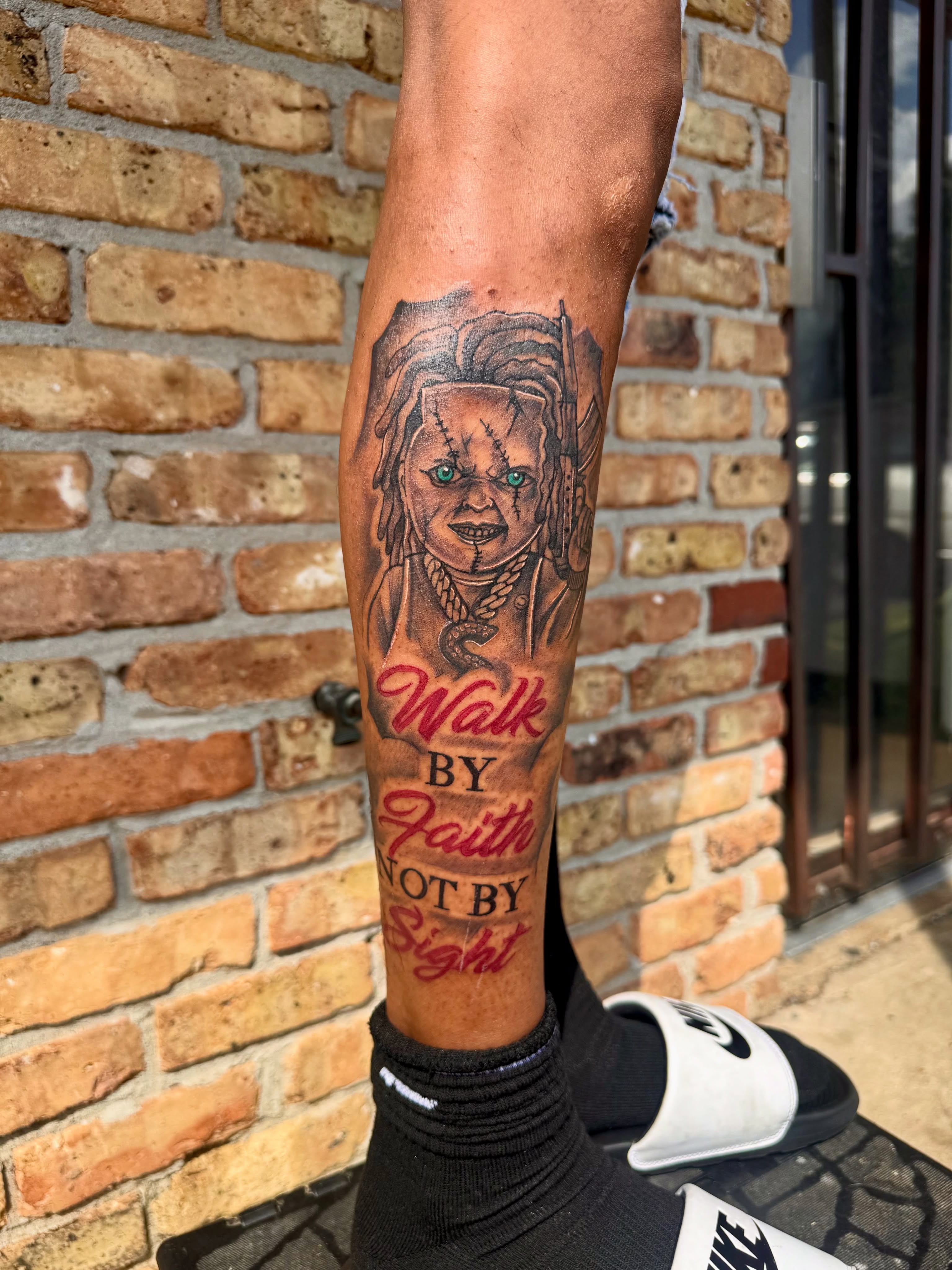 Chucky doll realism tattoo on the calf by GrindHard Quen