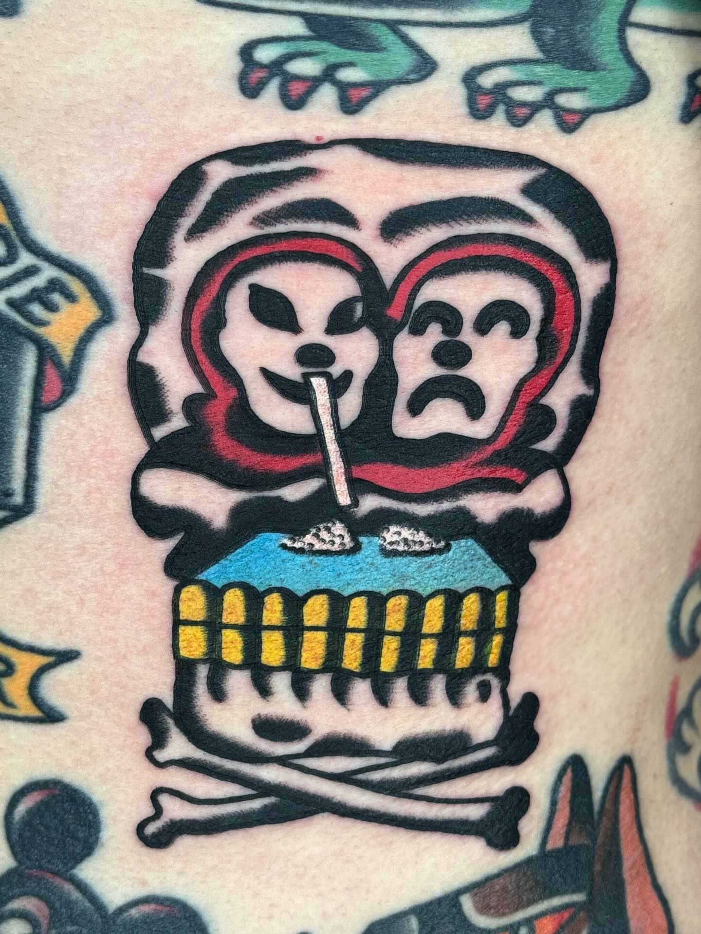 Skull with faces American traditional tattoo on the forearm by JAX