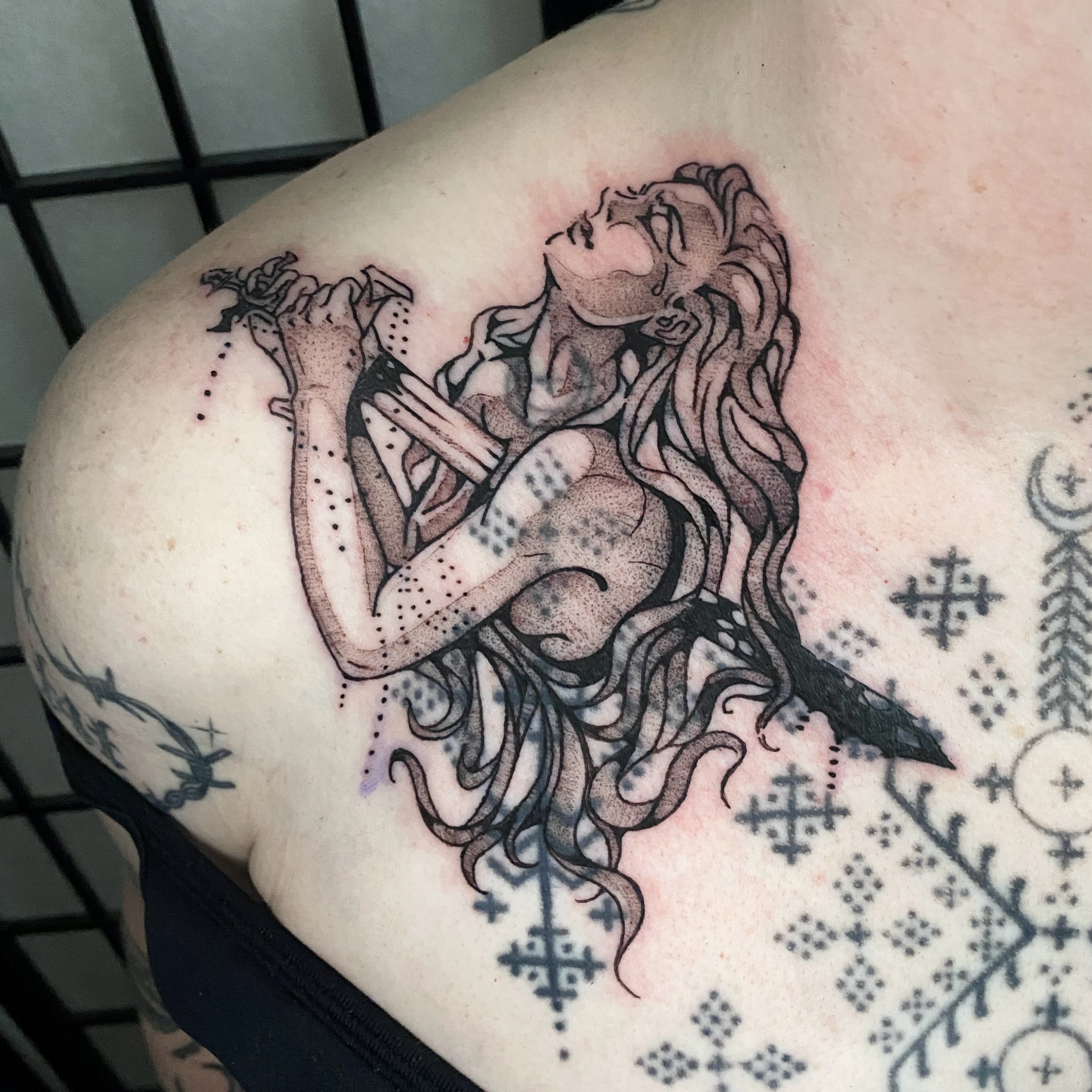 Woman with sword dotwork tattoo on the shoulder by Clara
