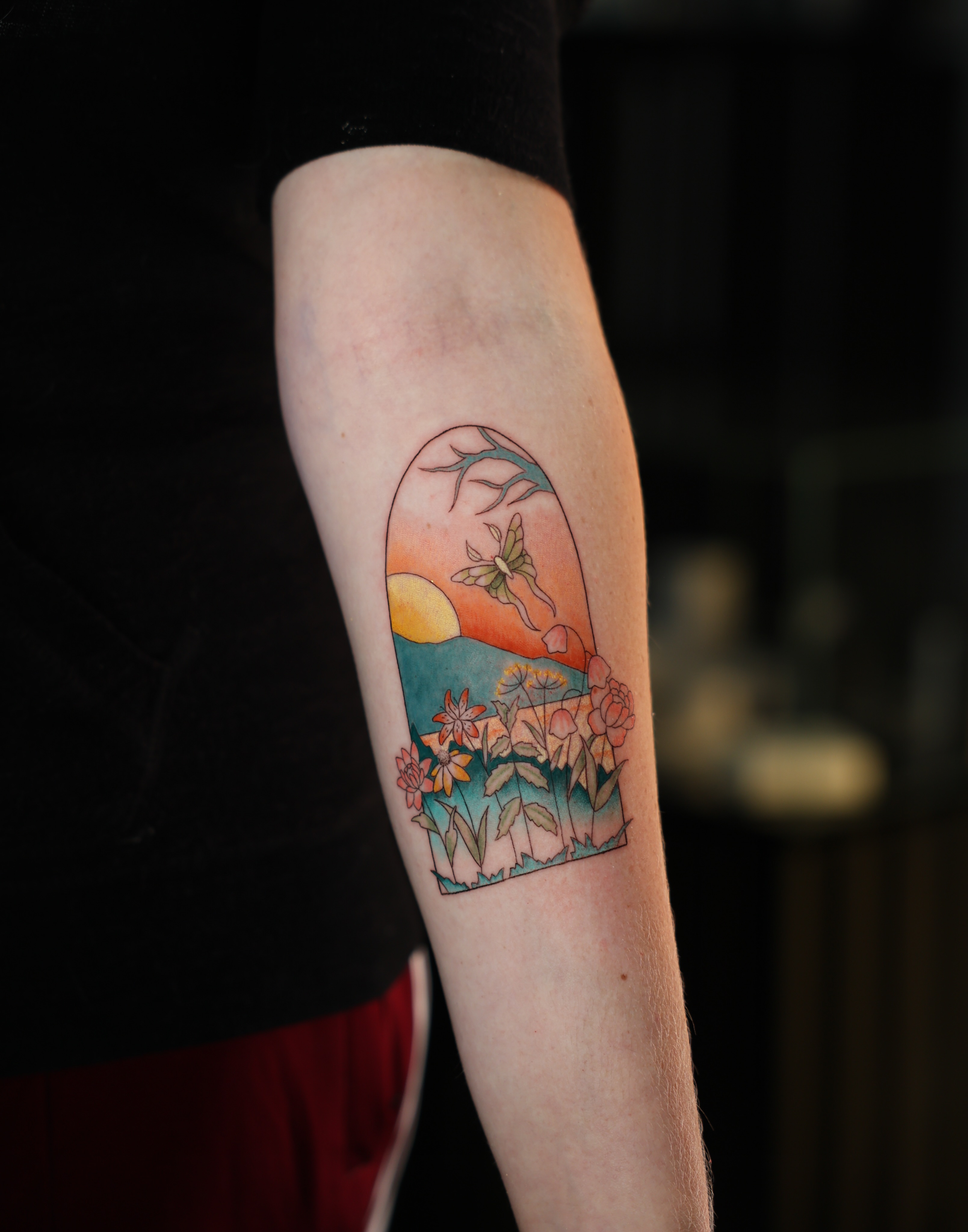 Sunset landscape new school tattoo on the forearm by Hannah Burnside, Charlotte, North Carolina