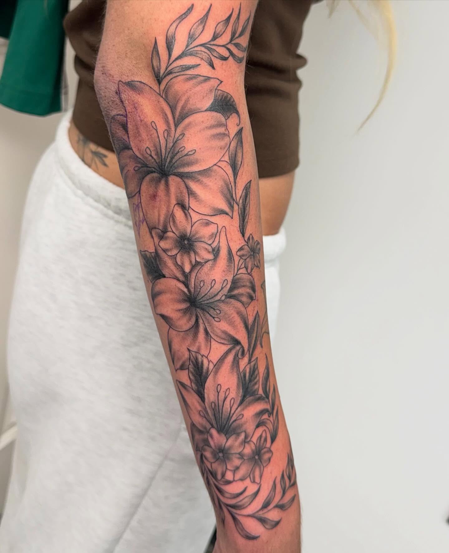 Lilies black and grey tattoo on the forearm by Brazun Locker Poloschan