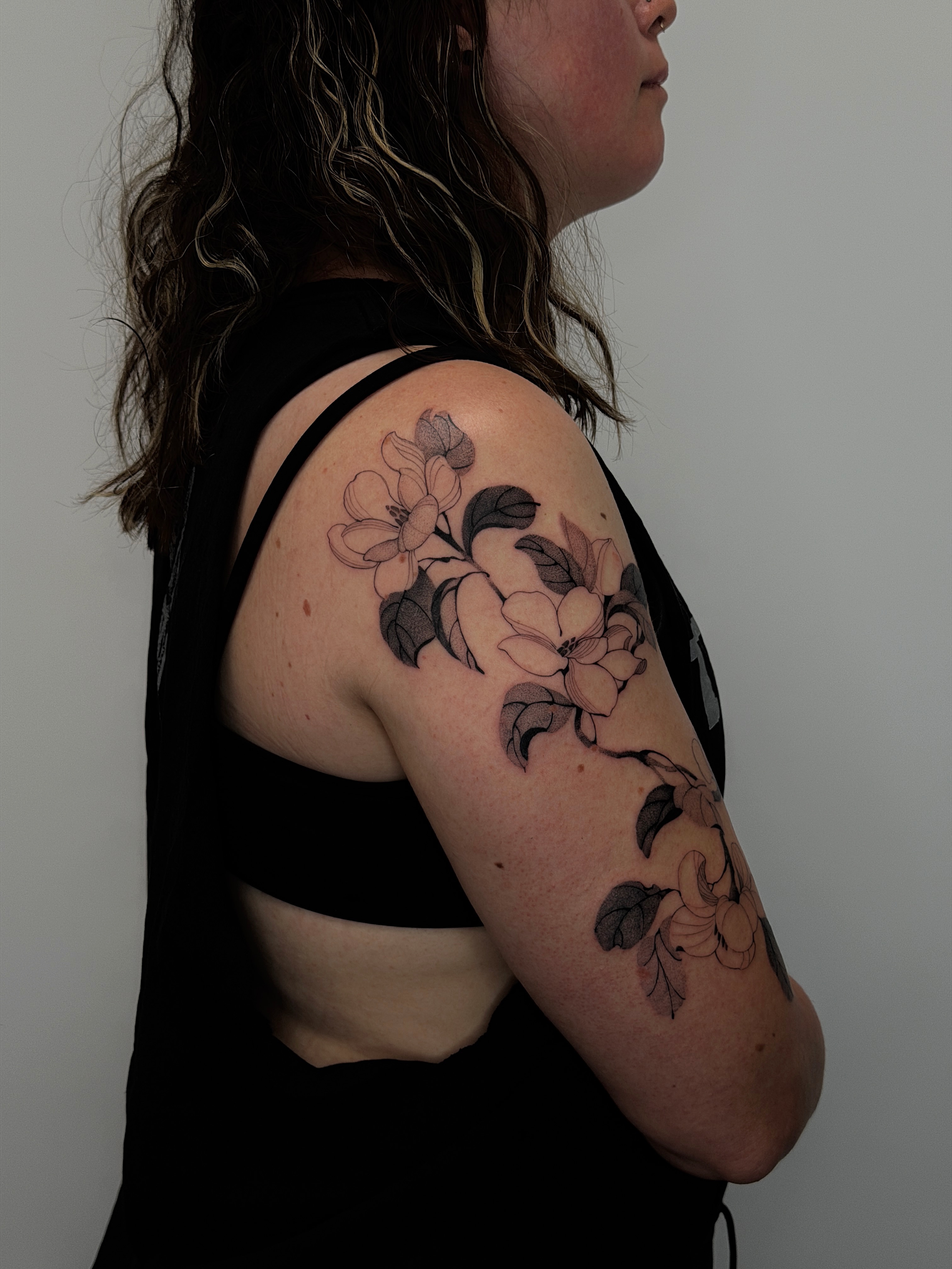 Flower bouquet black and grey tattoo on the upper arm by sago, Berkeley, California
