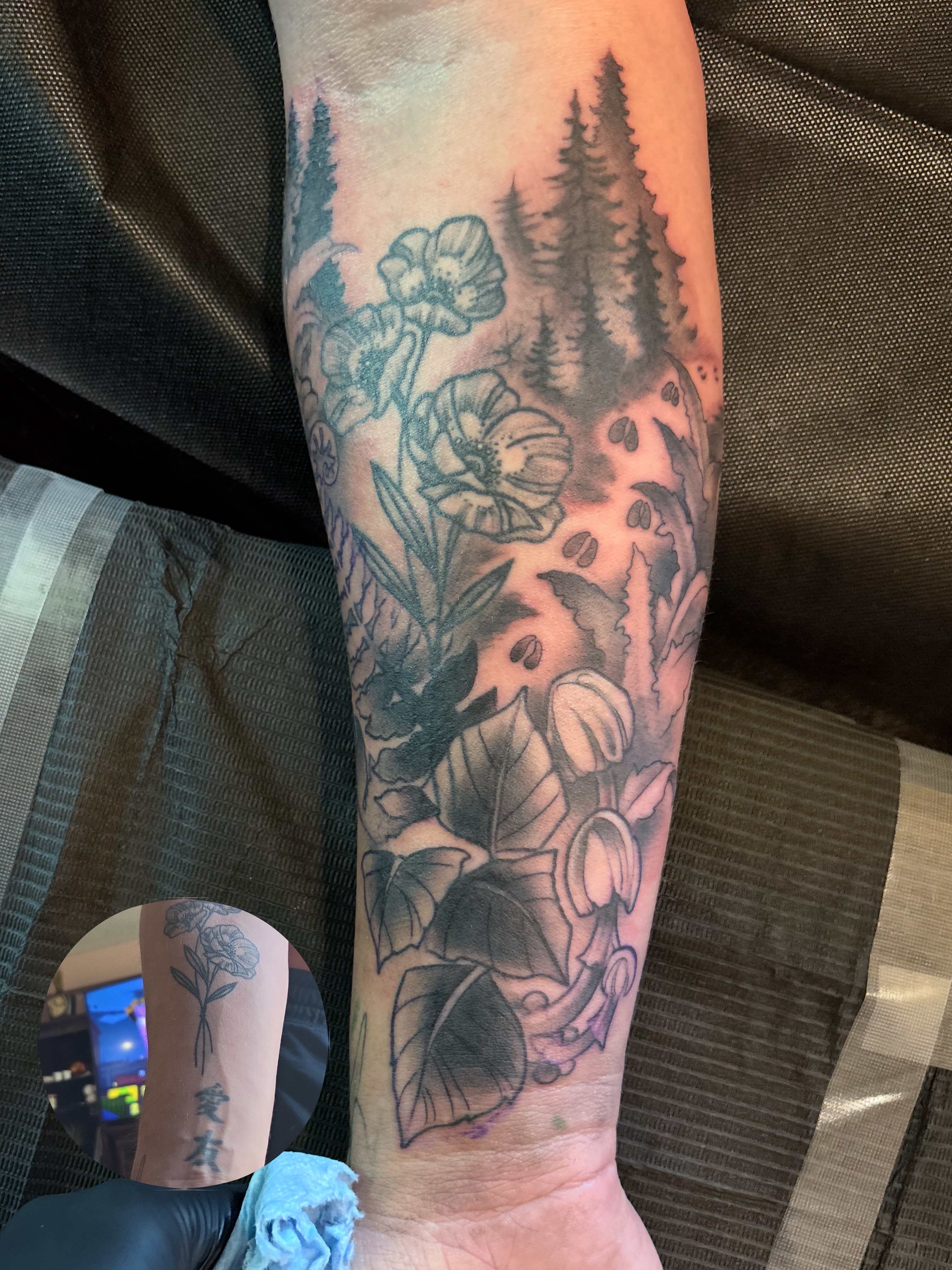Forest and flowers realism tattoo on the forearm by Komfort Kristy