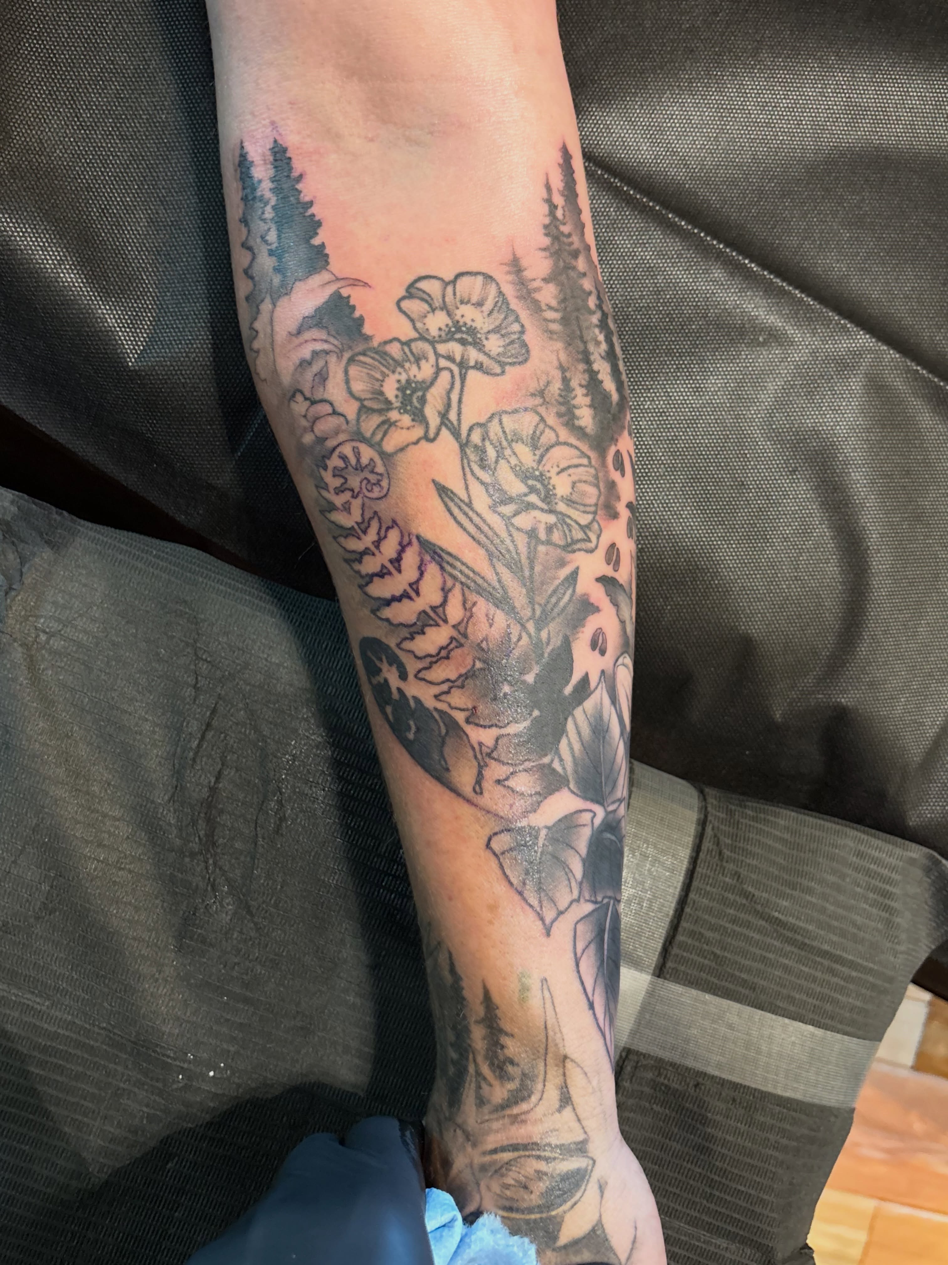 Floral bouquet black and grey tattoo on the forearm by Komfort Kristy