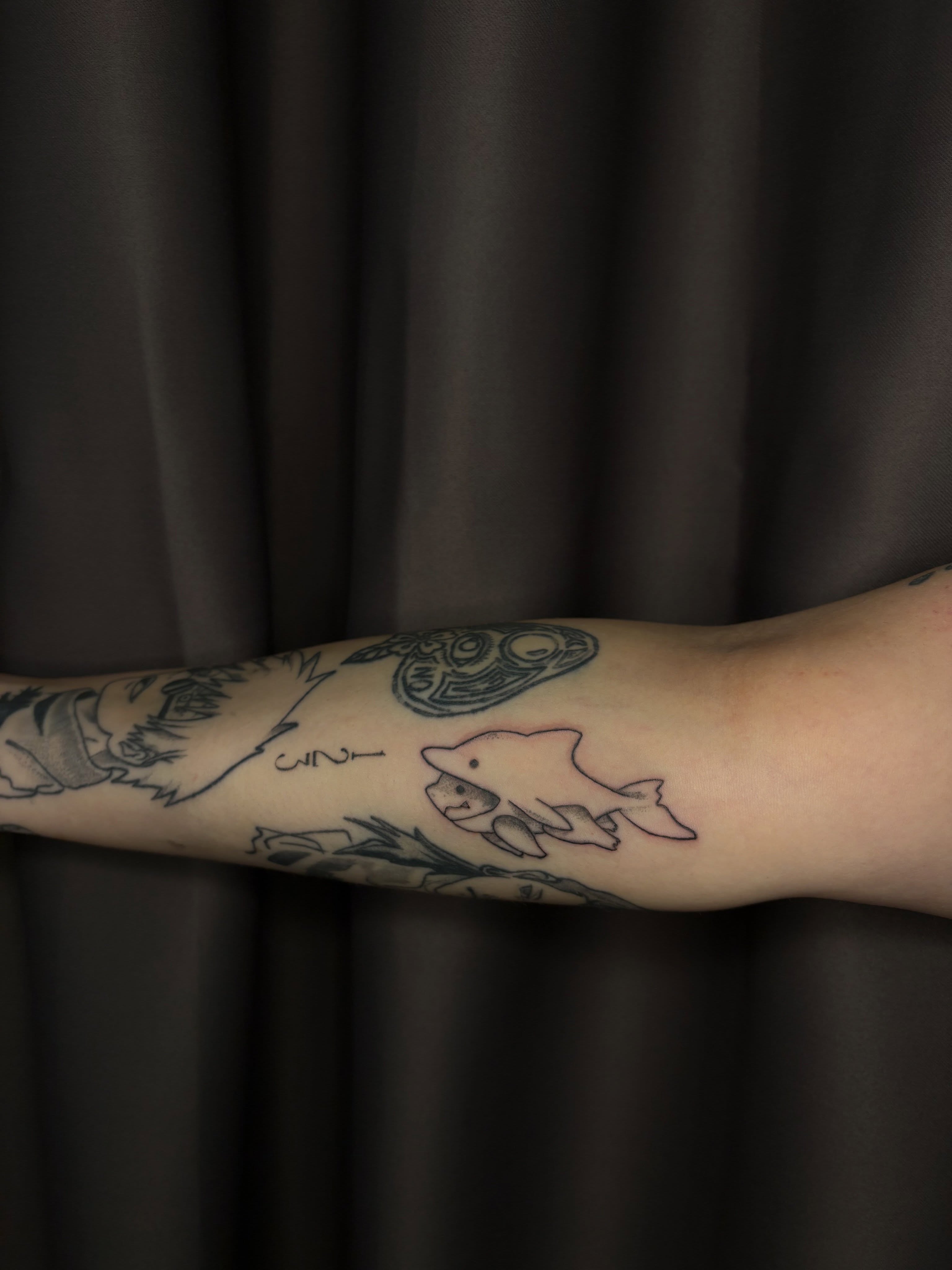 Dolphin and ship black and grey tattoo on the forearm by ✧˖°. Jordan