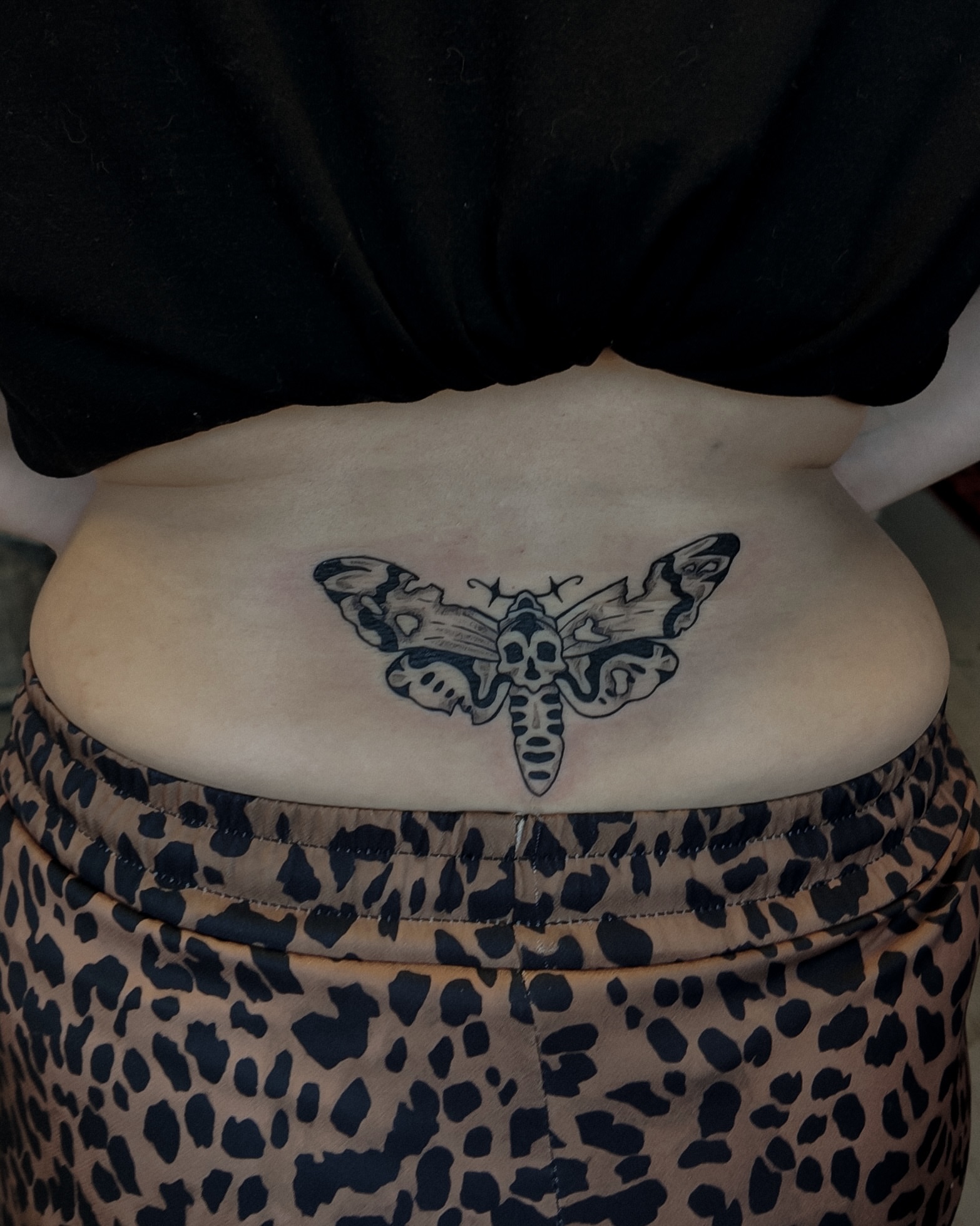 Moth black and grey tattoo on the torso by Morgan Diann