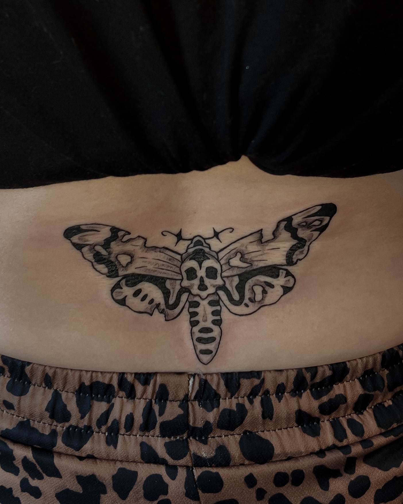 Death's-head moth black and grey tattoo on the torso by Morgan Diann