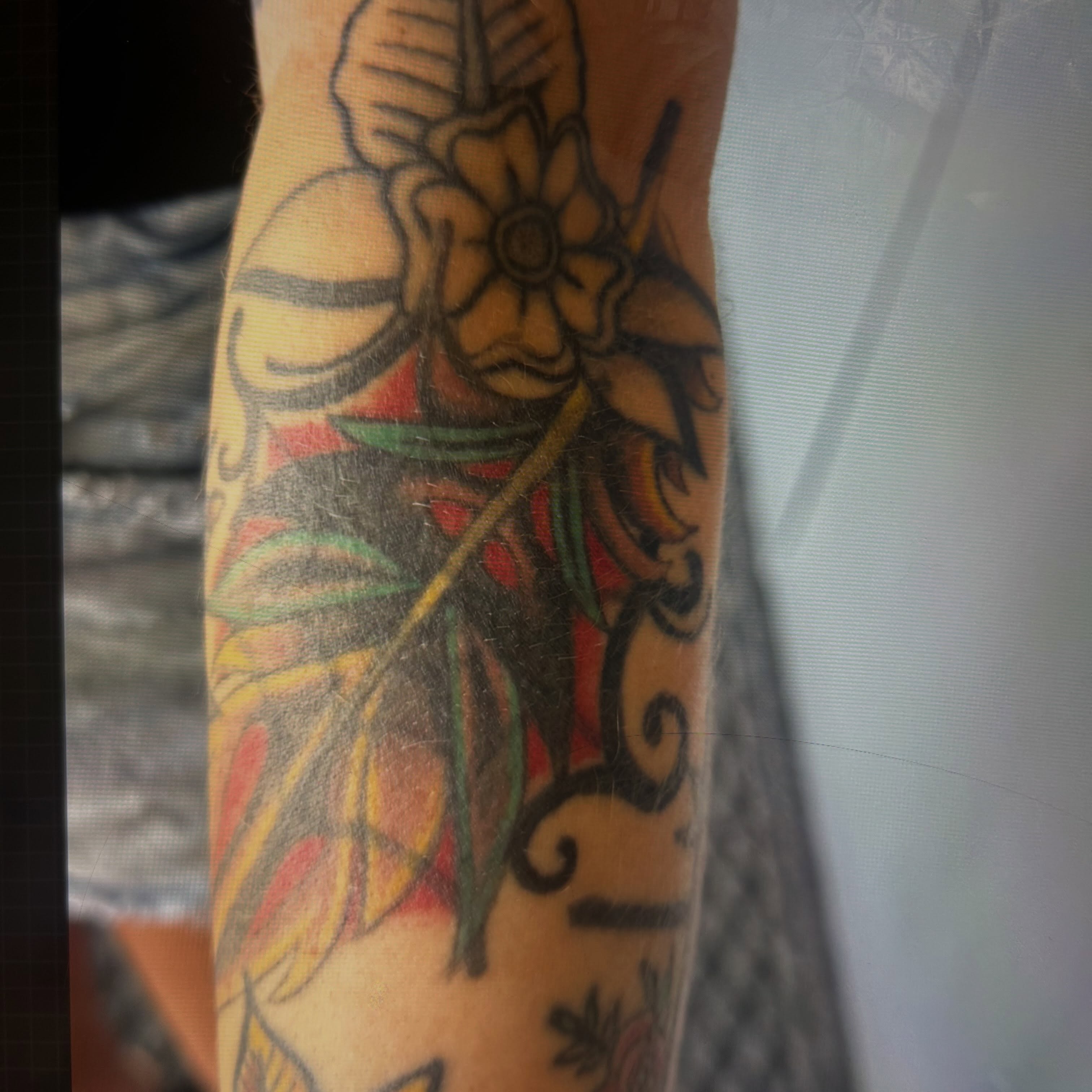 Flower and leaves American traditional tattoo on the forearm by Jamie Winn