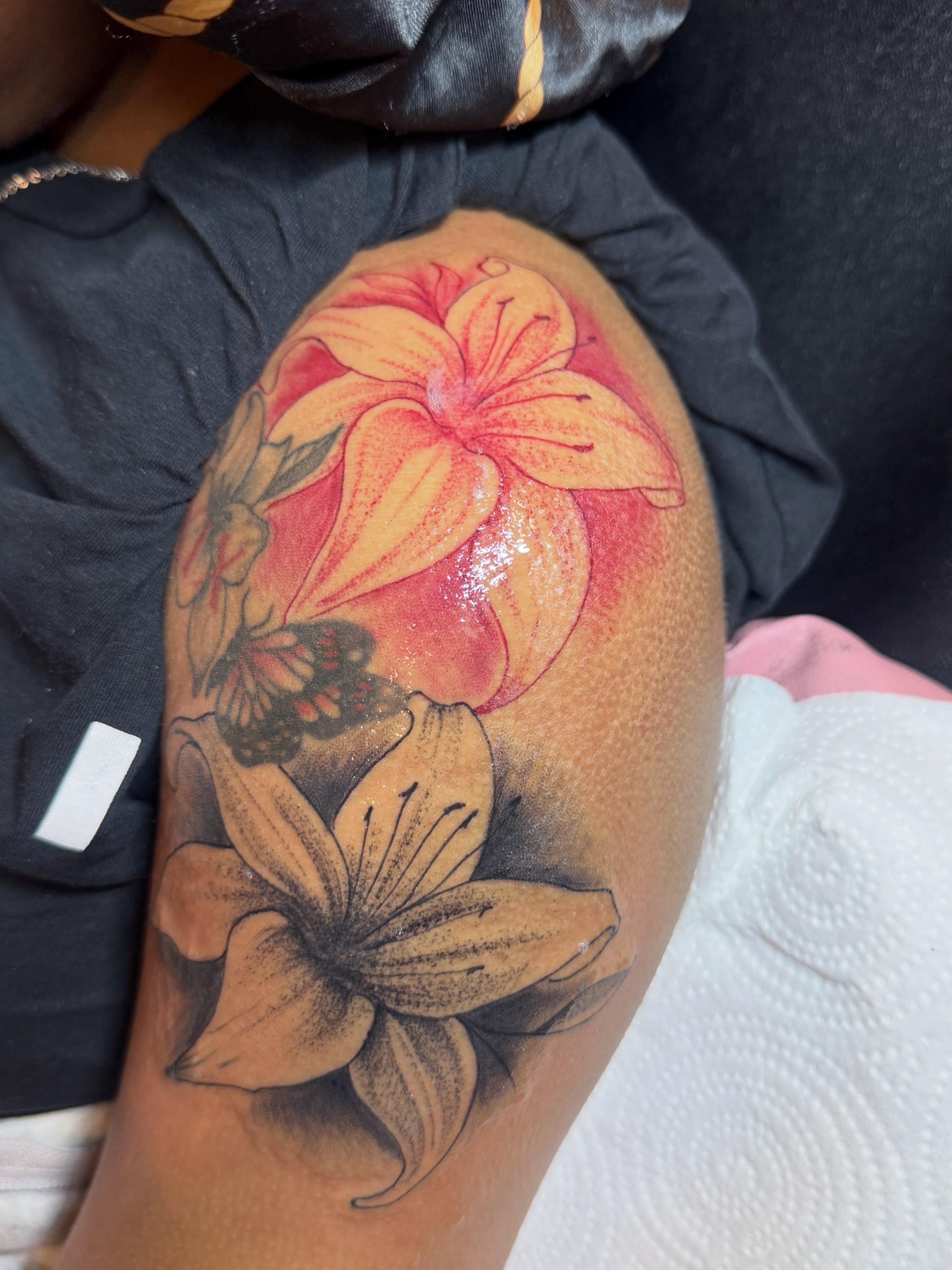 Lilies and butterfly realism tattoo on the shoulder by Destini