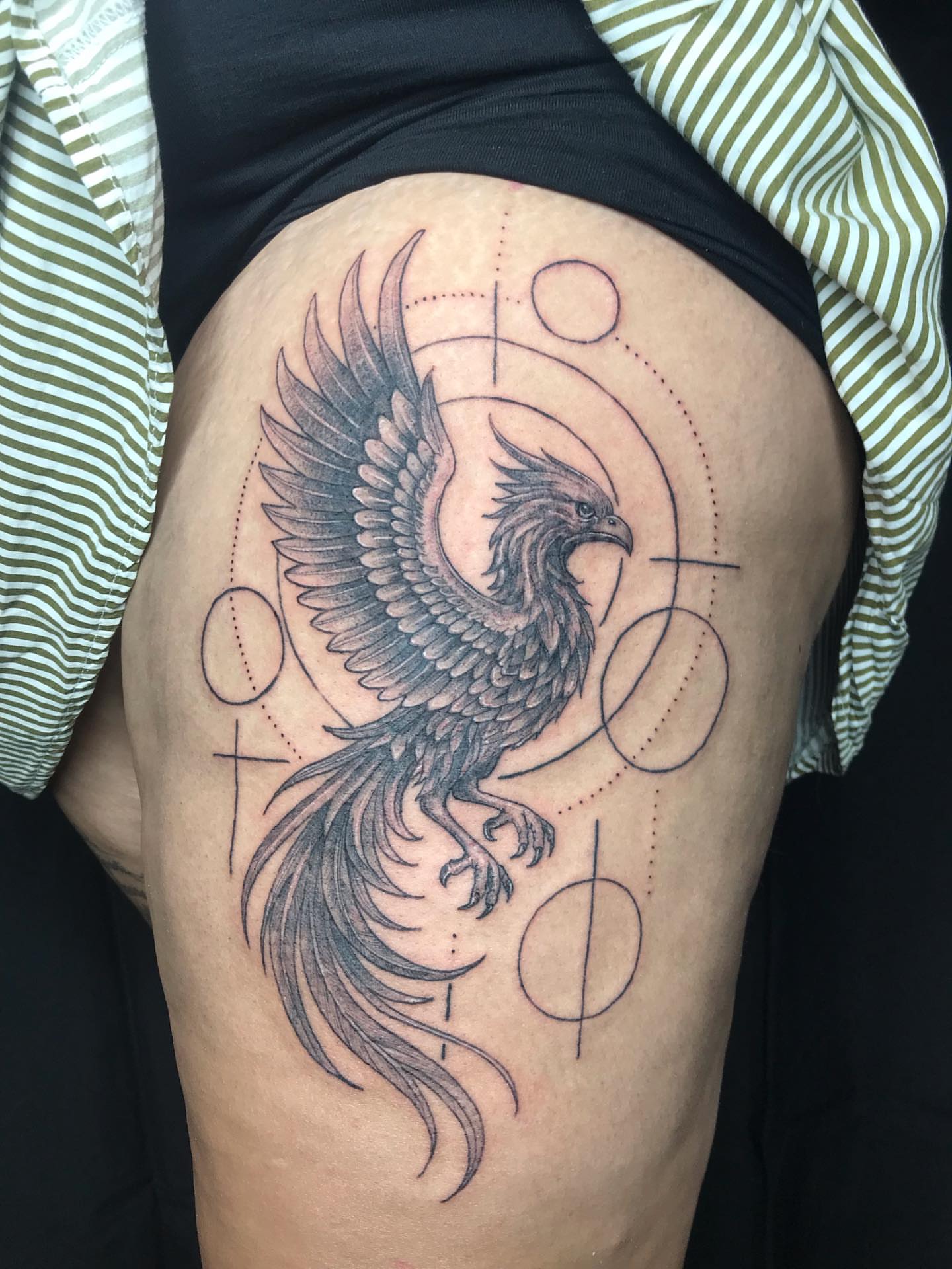 Phoenix black and grey tattoo on the thigh by Moss Quito Tattoo