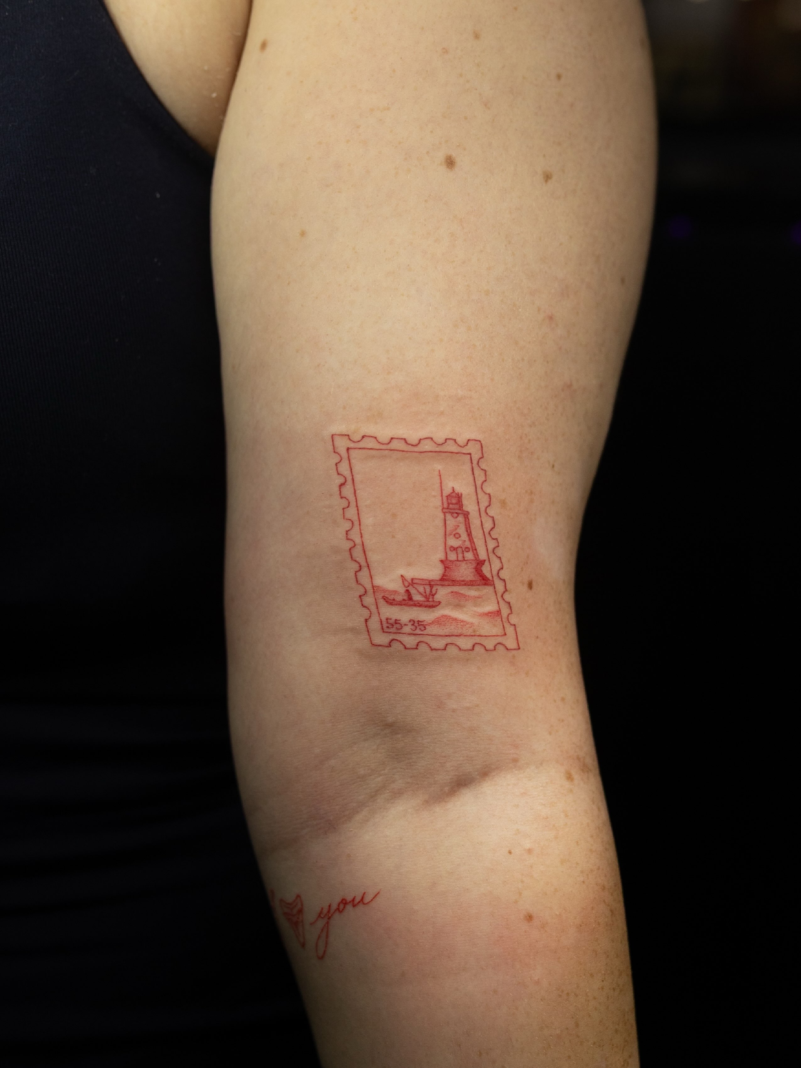 Lighthouse stamp dotwork tattoo on the forearm by Kelsie