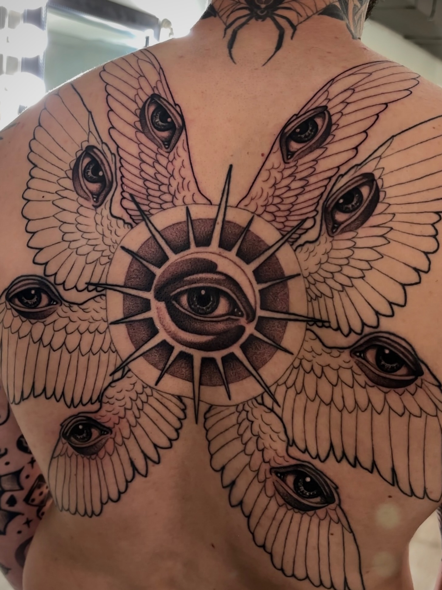 Eye with wings geometric tattoo on the back by Tara, Exeter, Pennsylvania