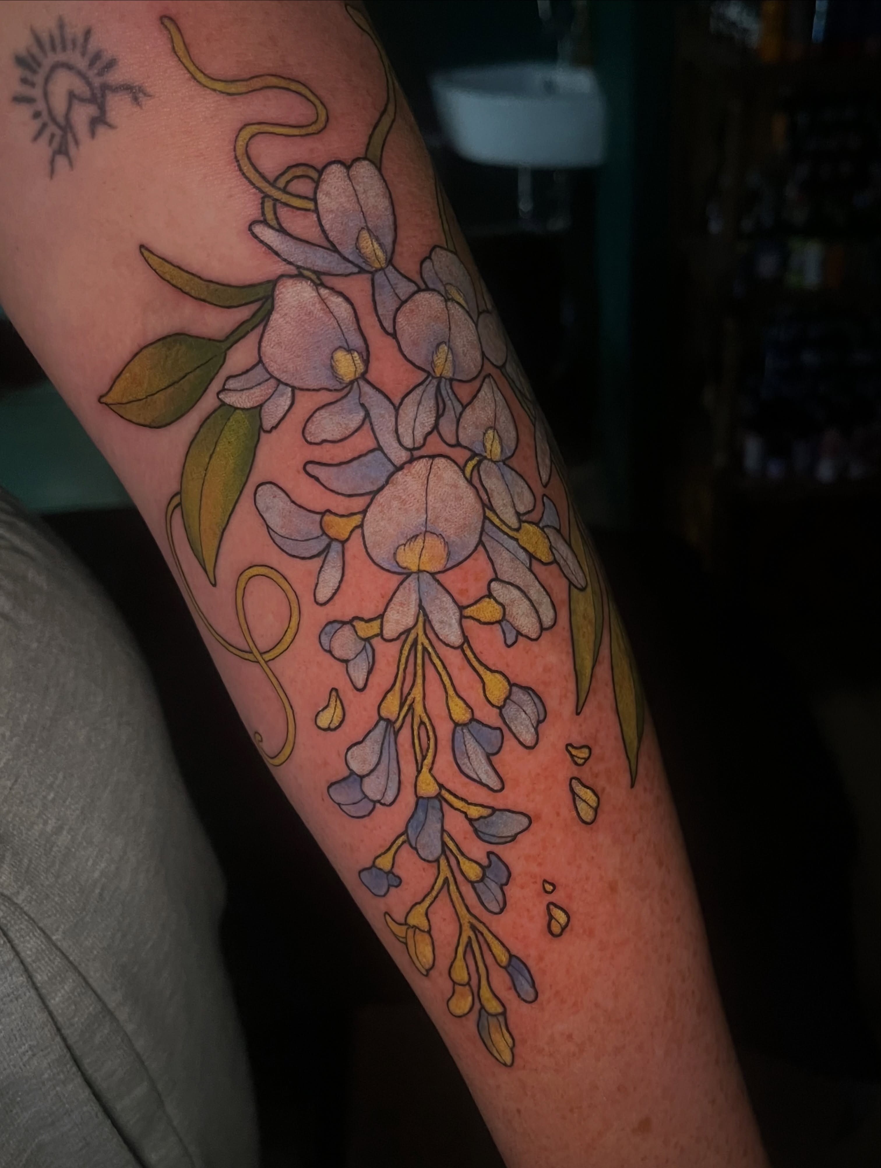 Wisteria flowers new school tattoo on the forearm by Summer Machelle, Orange, California