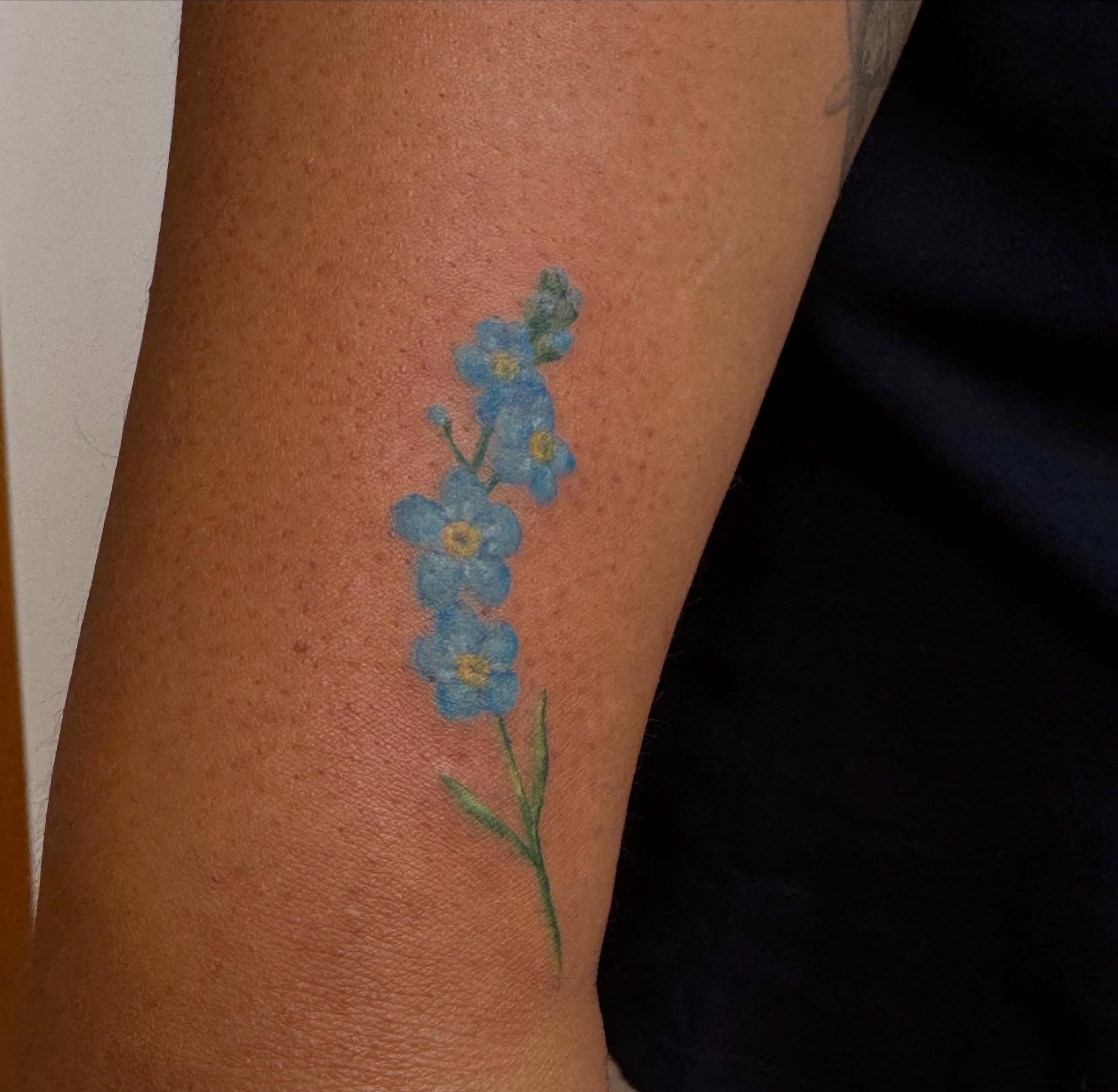 Forget-me-not flowers watercolor tattoo on the forearm by Enda 🧚🏻‍♀️