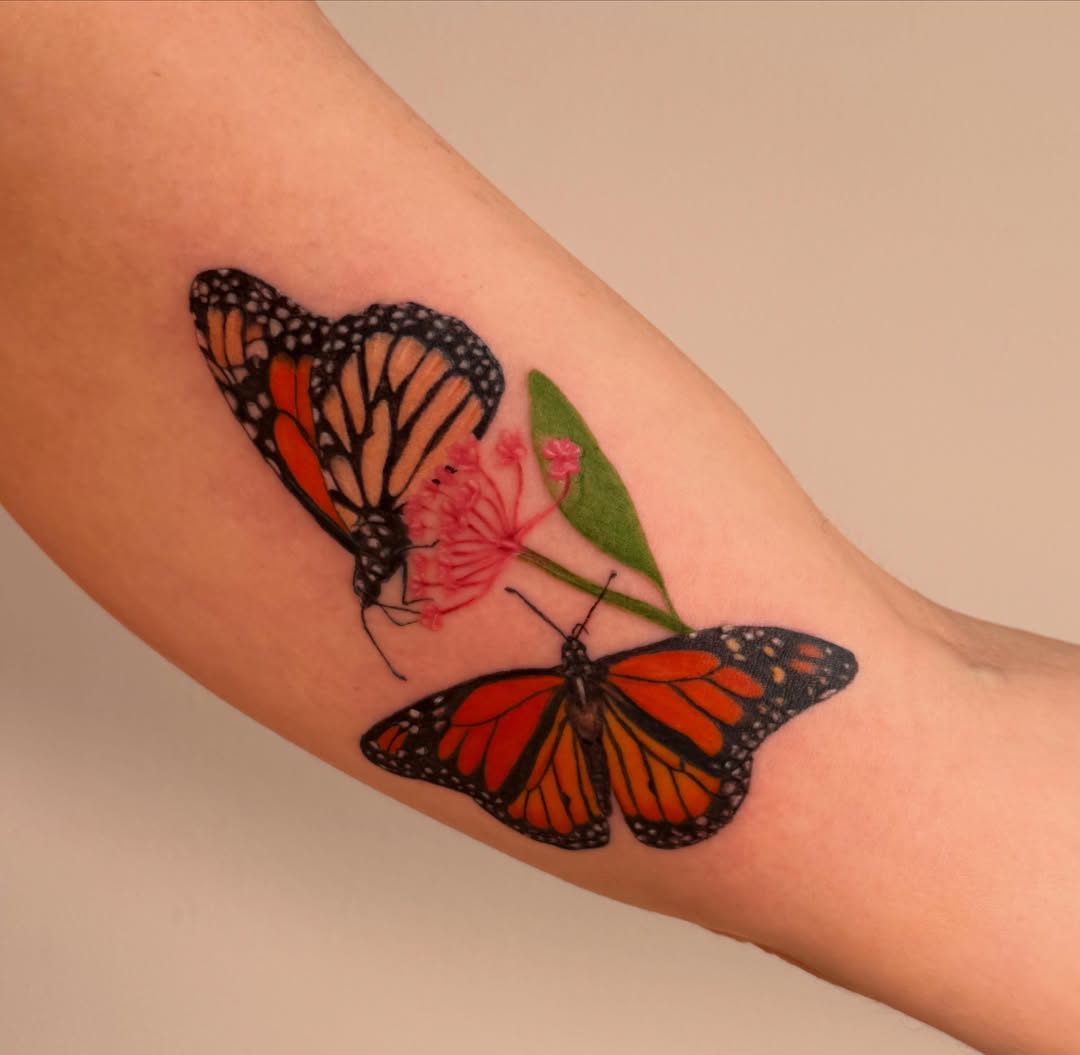 Monarch butterflies and flower realism tattoo on the forearm by Enda 🧚🏻‍♀️