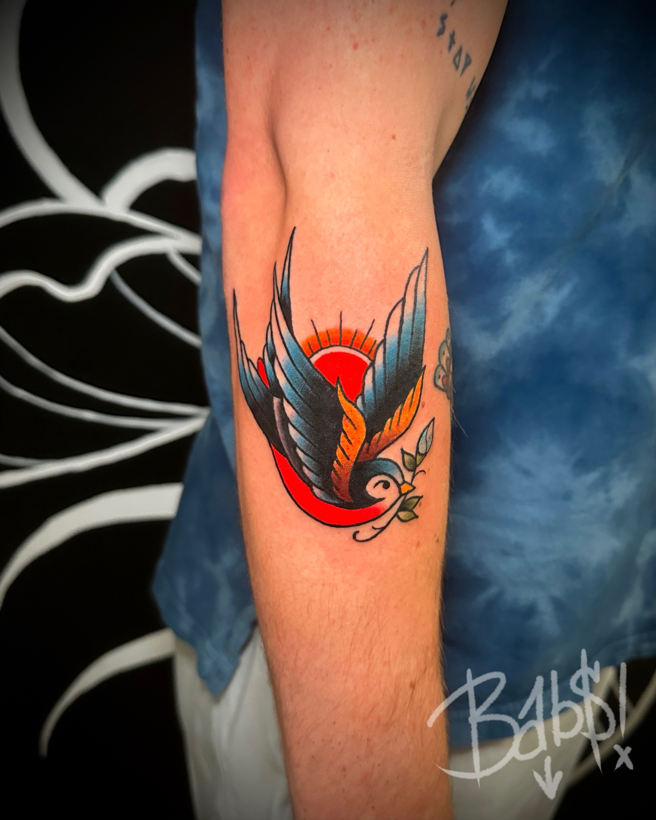 Swallow American traditional tattoo on the forearm by Justin B