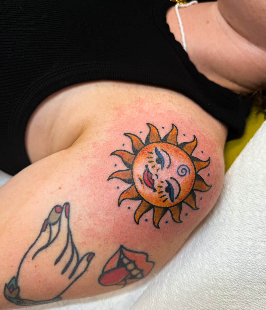Sun American traditional tattoo on the thigh by Hannah Eddy