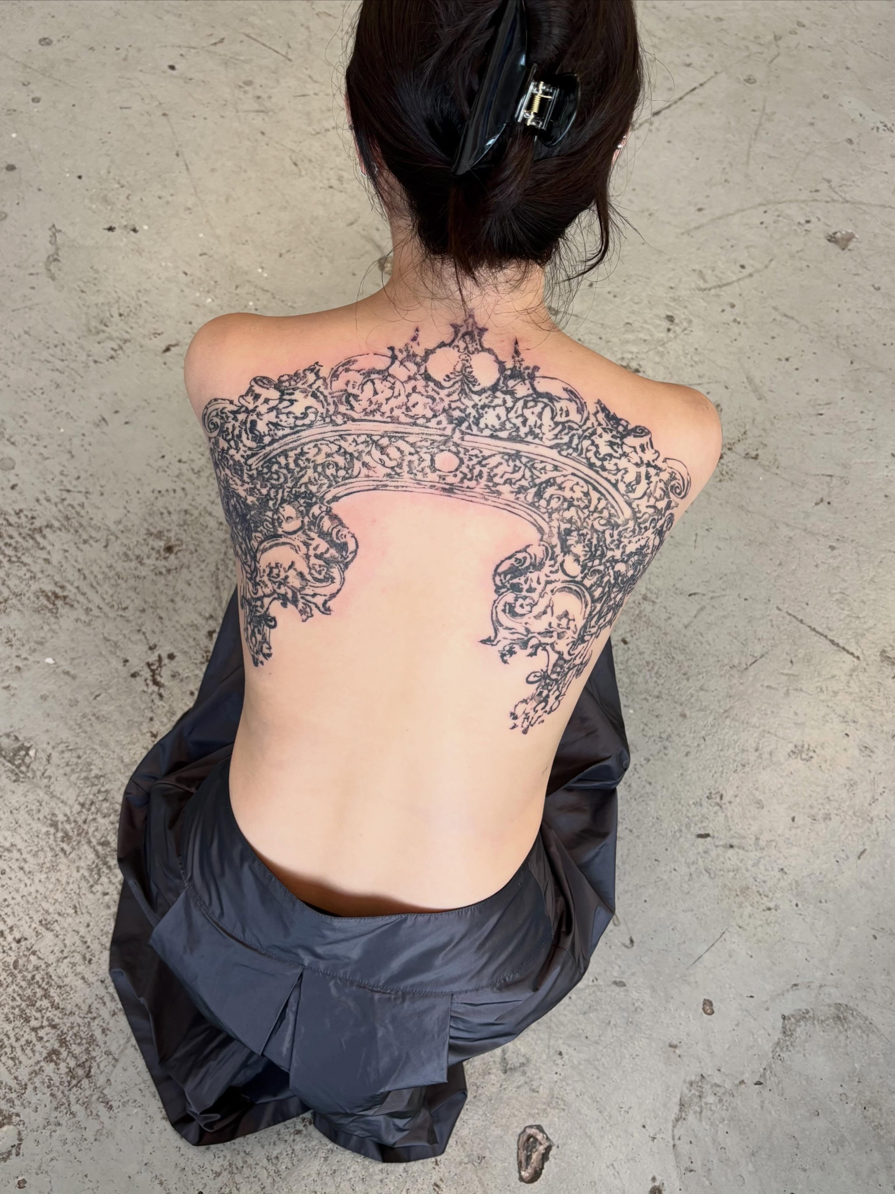Ornate crown ornamental tattoo on the back by madeline
