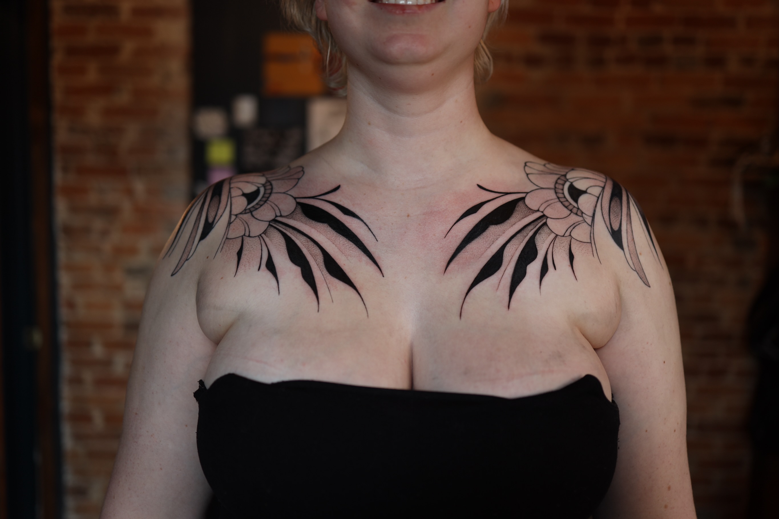 Floral black and grey tattoo on the chest by morgan purcey