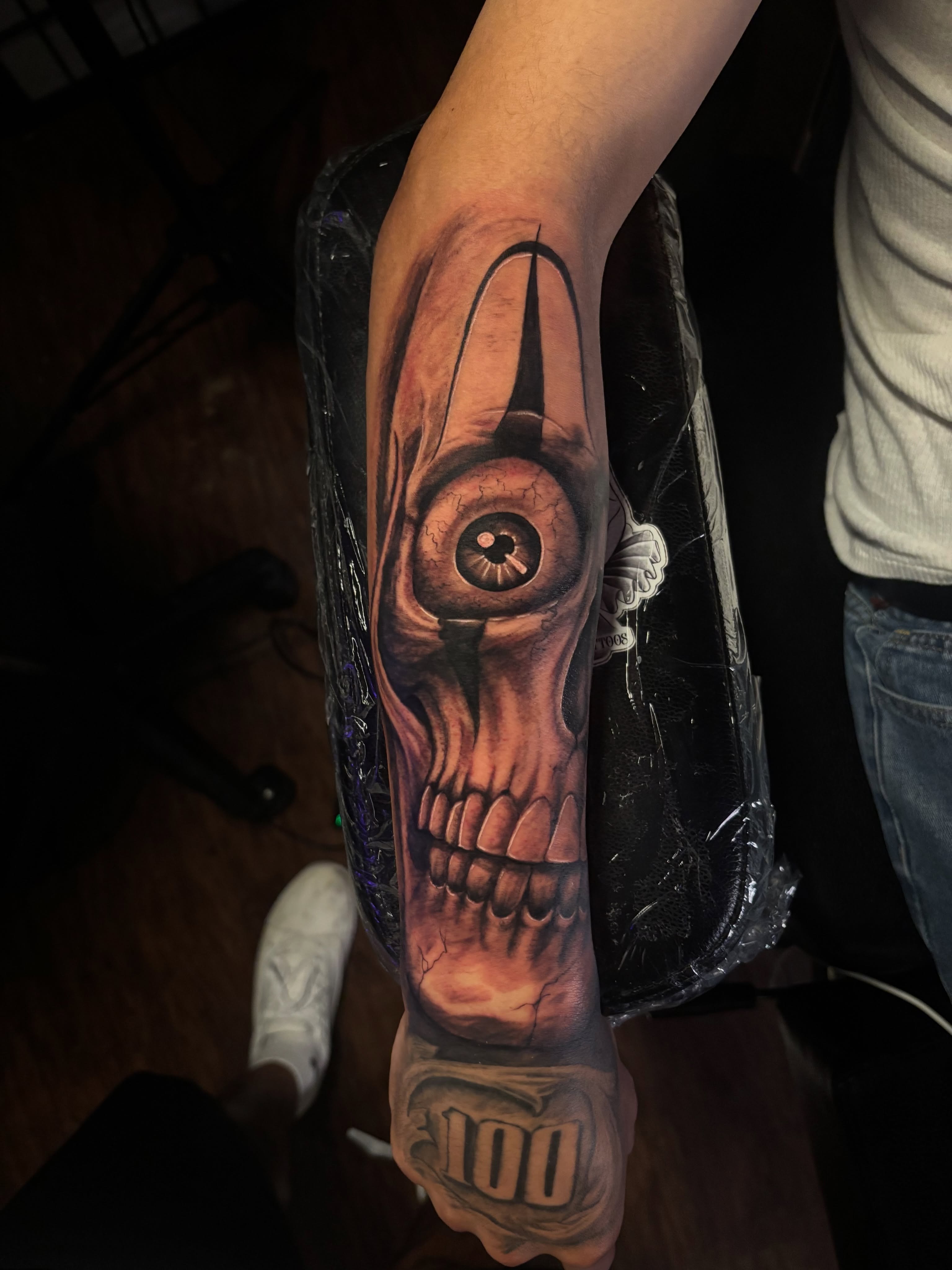 Eye and skull realism tattoo on the forearm by Terik Whittaker