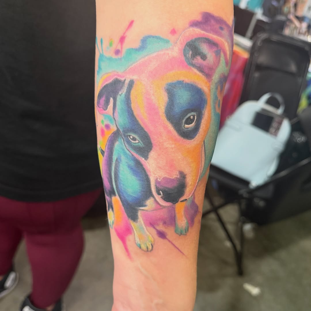Dog watercolor tattoo on the forearm by Loki Shane DeFriece