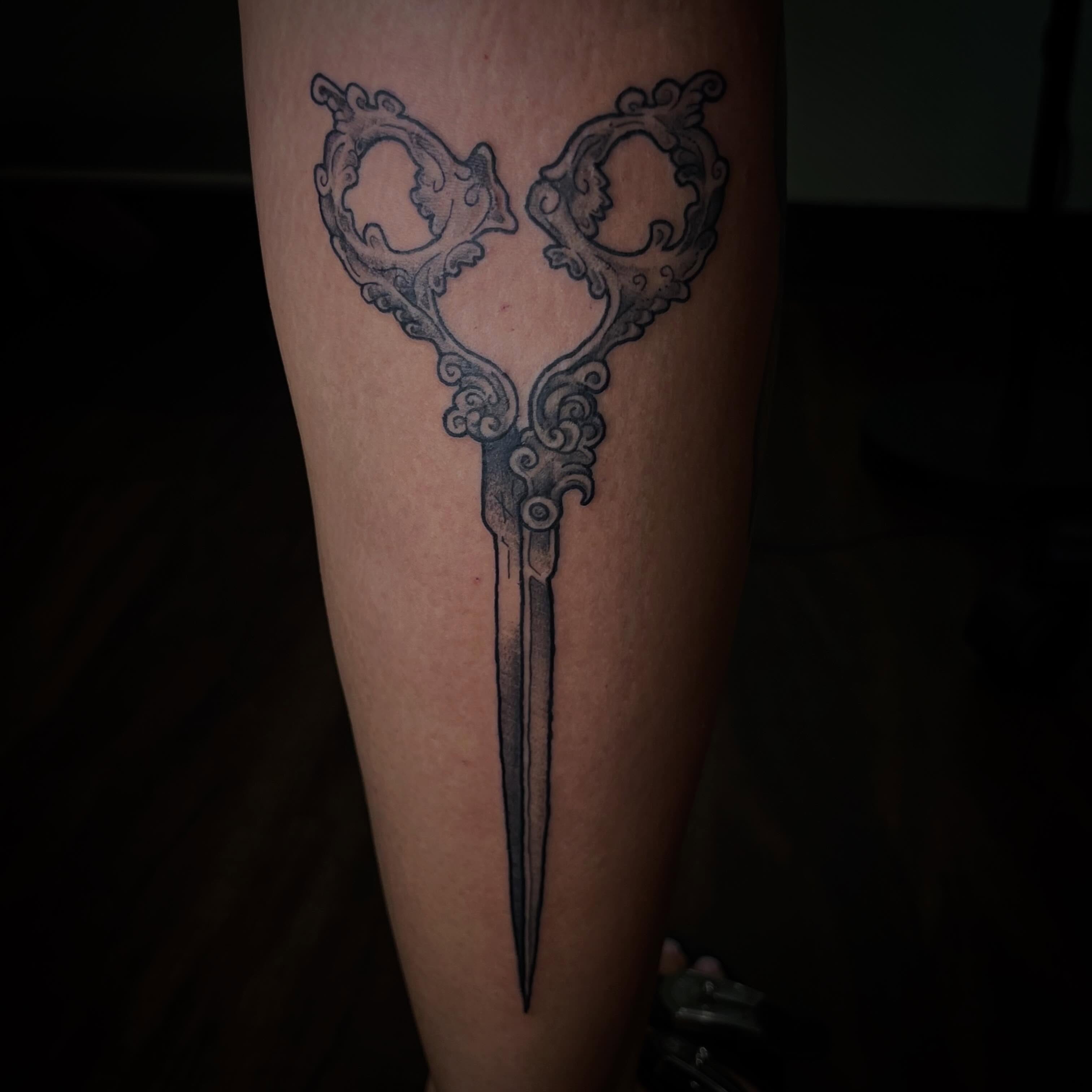 Scissors black and grey tattoo on the forearm by Jazzy