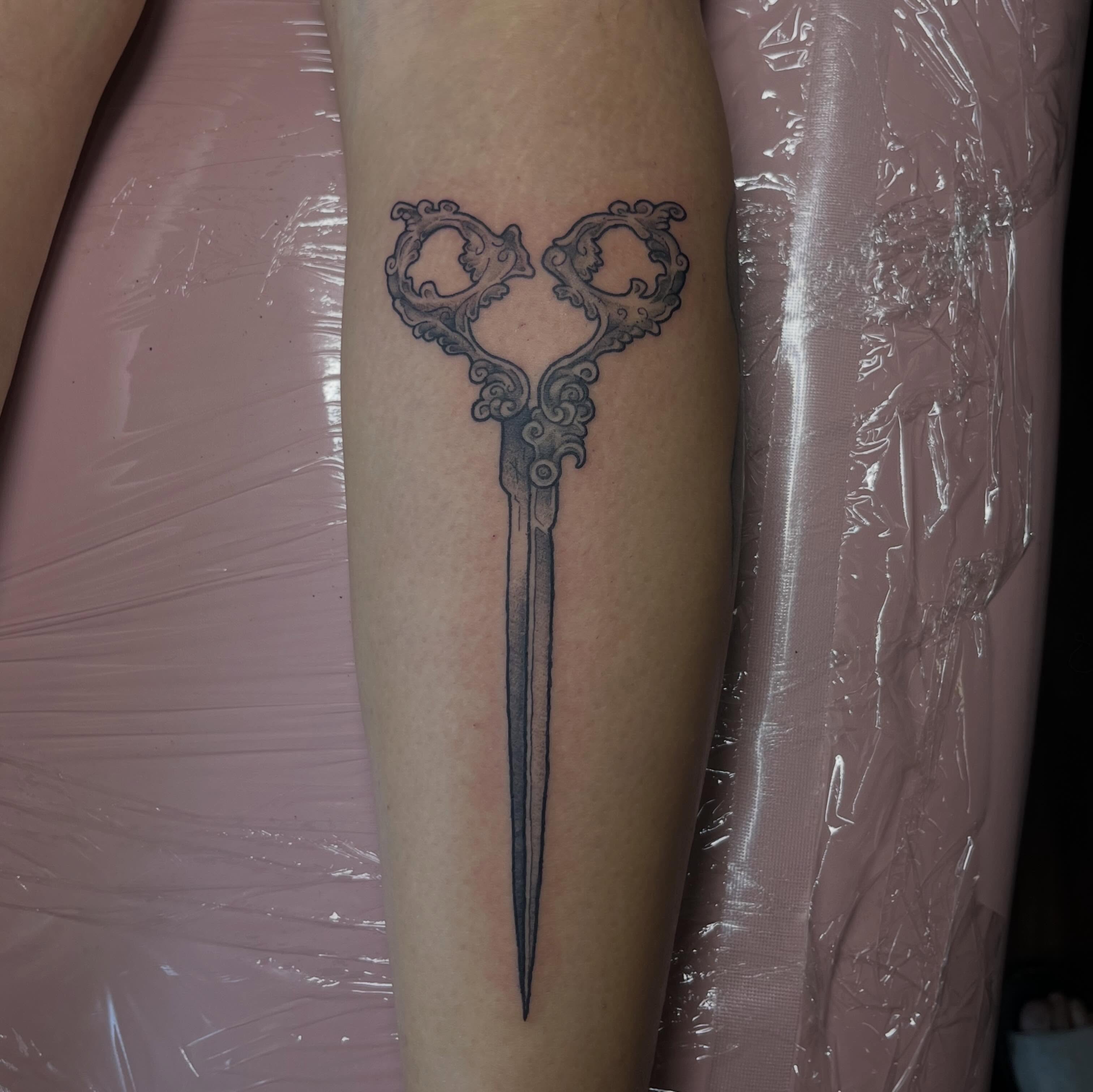 Scissors black and grey tattoo on the forearm by Jazzy
