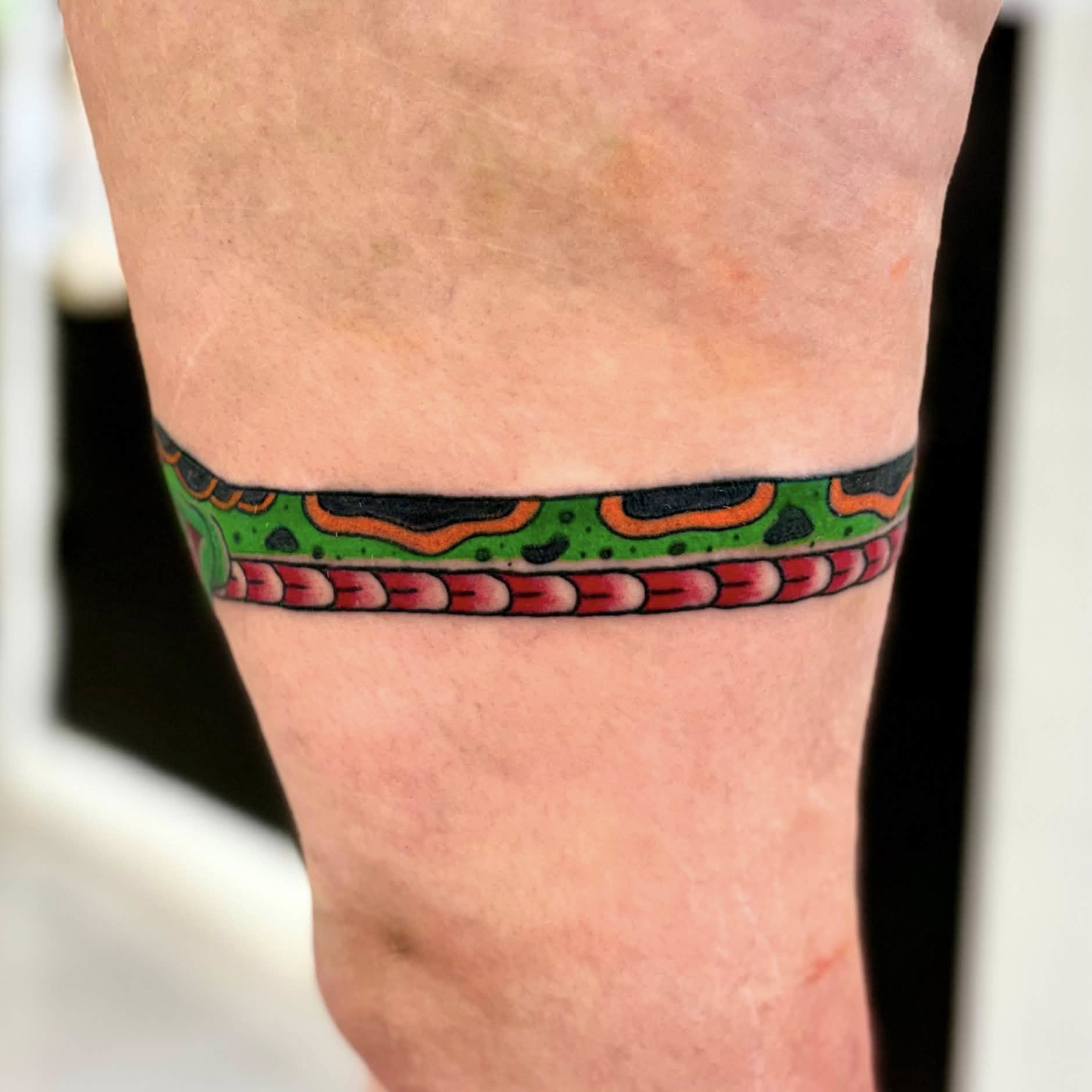 Snake trash polka tattoo on the forearm by Jon Anderson