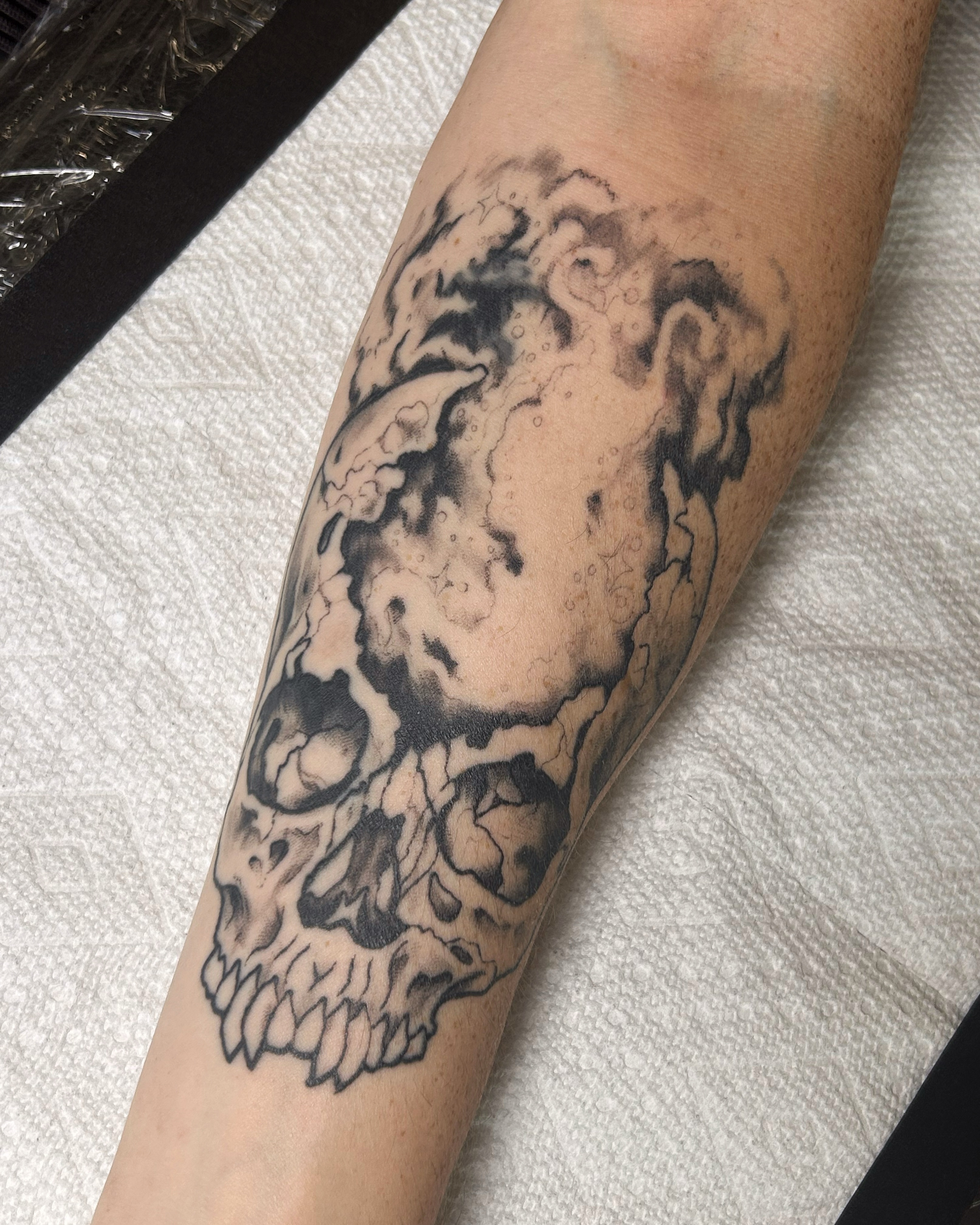 Skull black and grey tattoo on the forearm by Zephyr