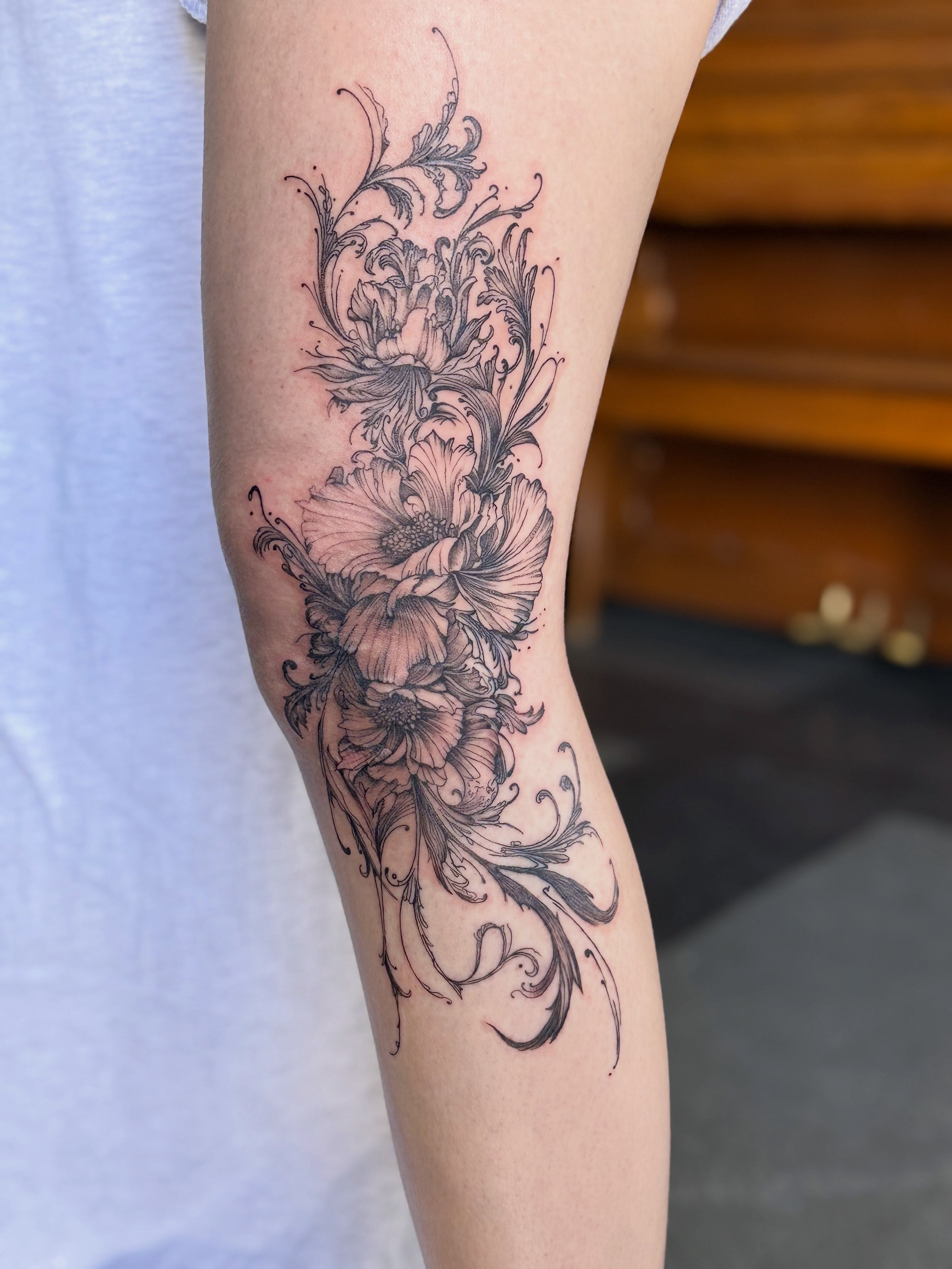 Floral arrangement black and grey tattoo on the forearm by Tetiana