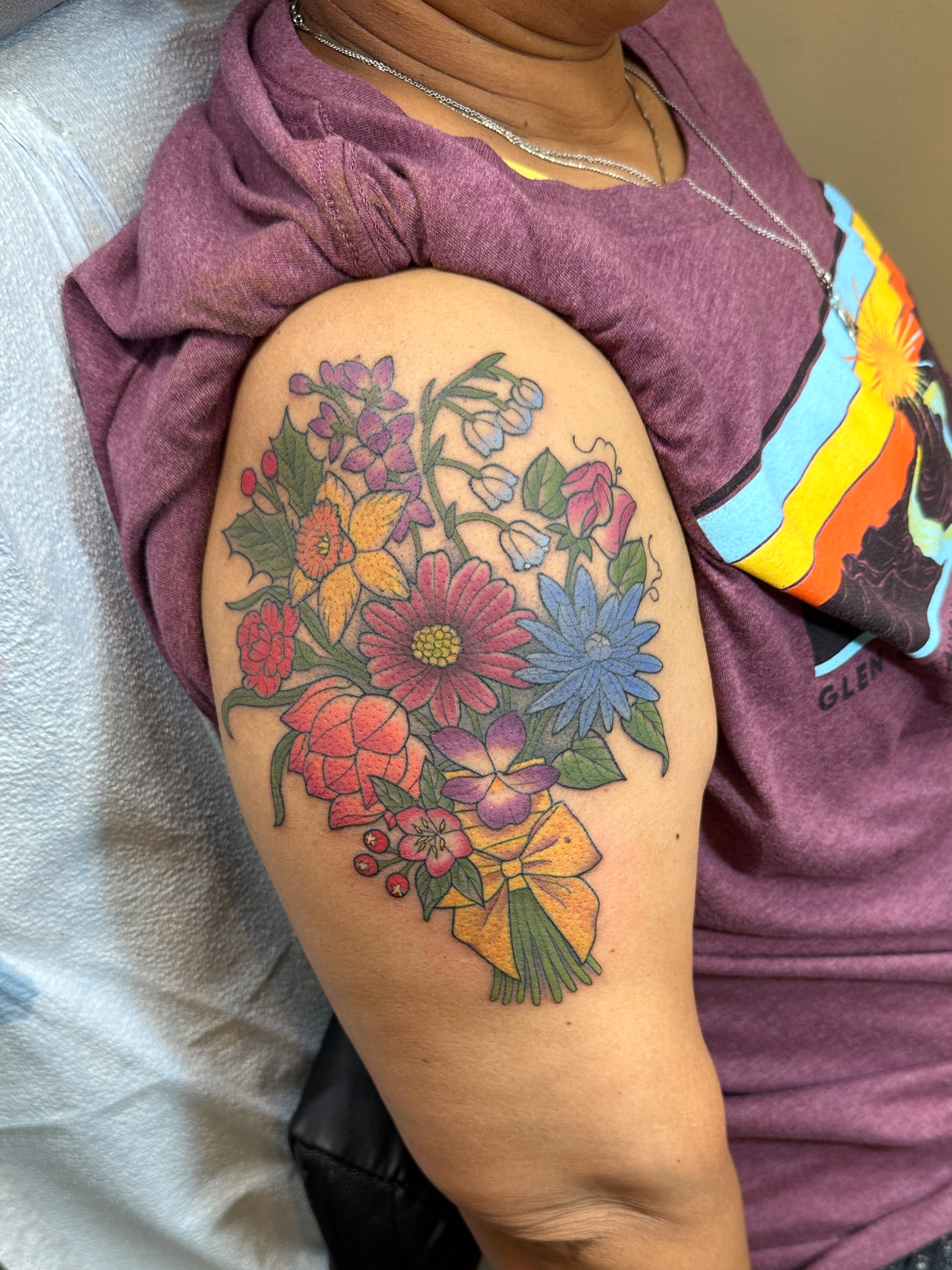 Floral bouquet new school tattoo on the shoulder by Tattooing by Patty Valentine