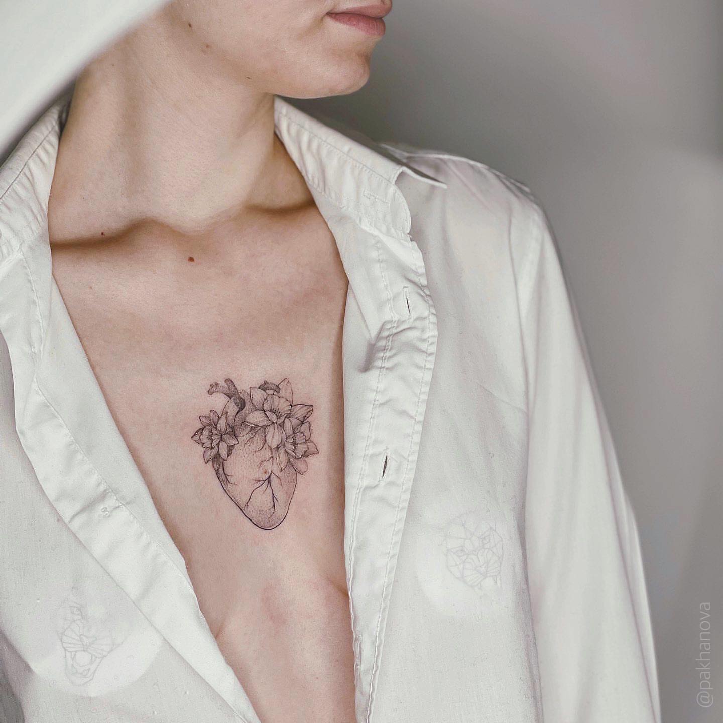 Heart with flowers black and grey tattoo on the chest by Anastasiia Pakhanova ♥ tattoo artist
