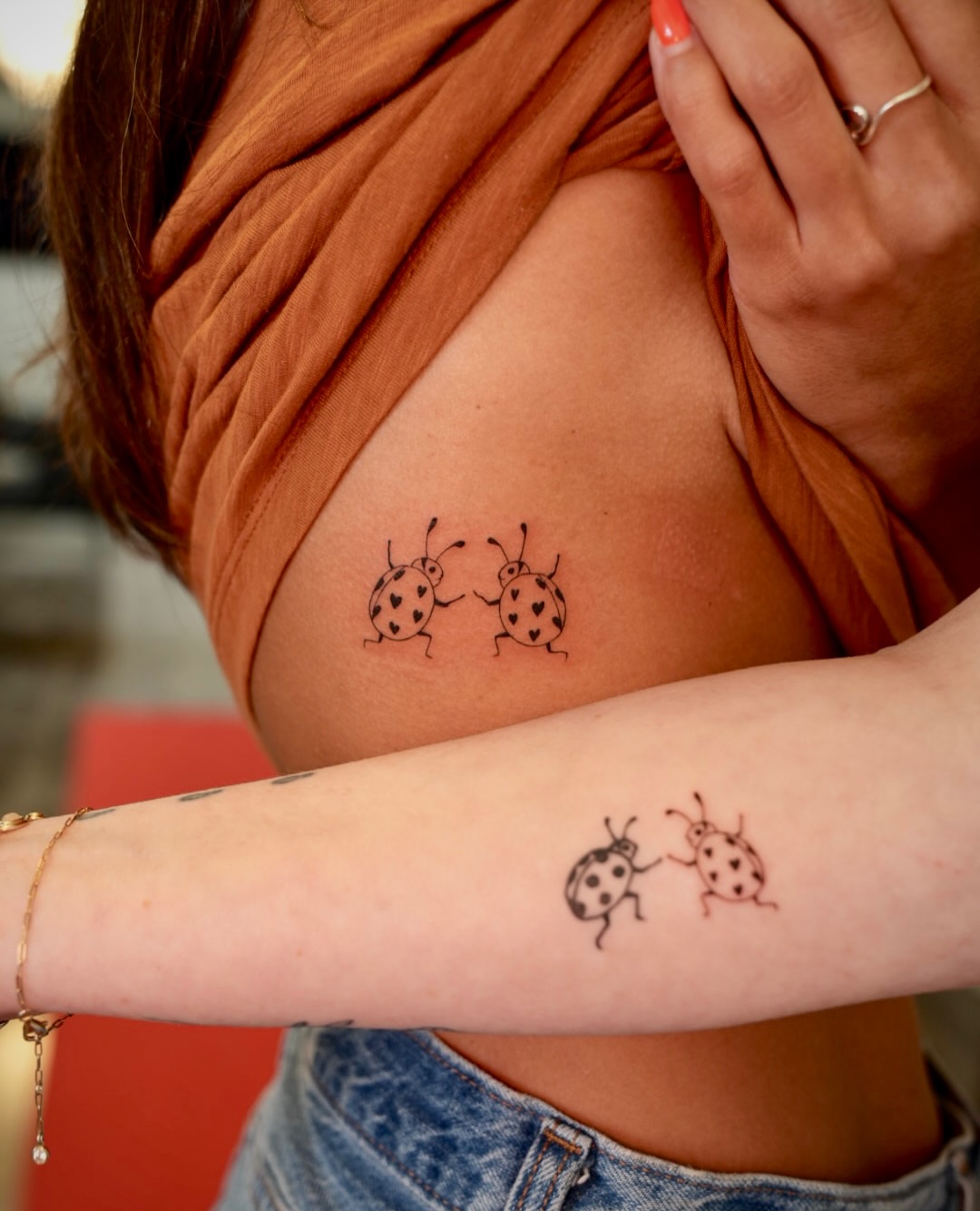 Ladybugs minimalist tattoo on the upper arm by 🤍 Sarah 🖤