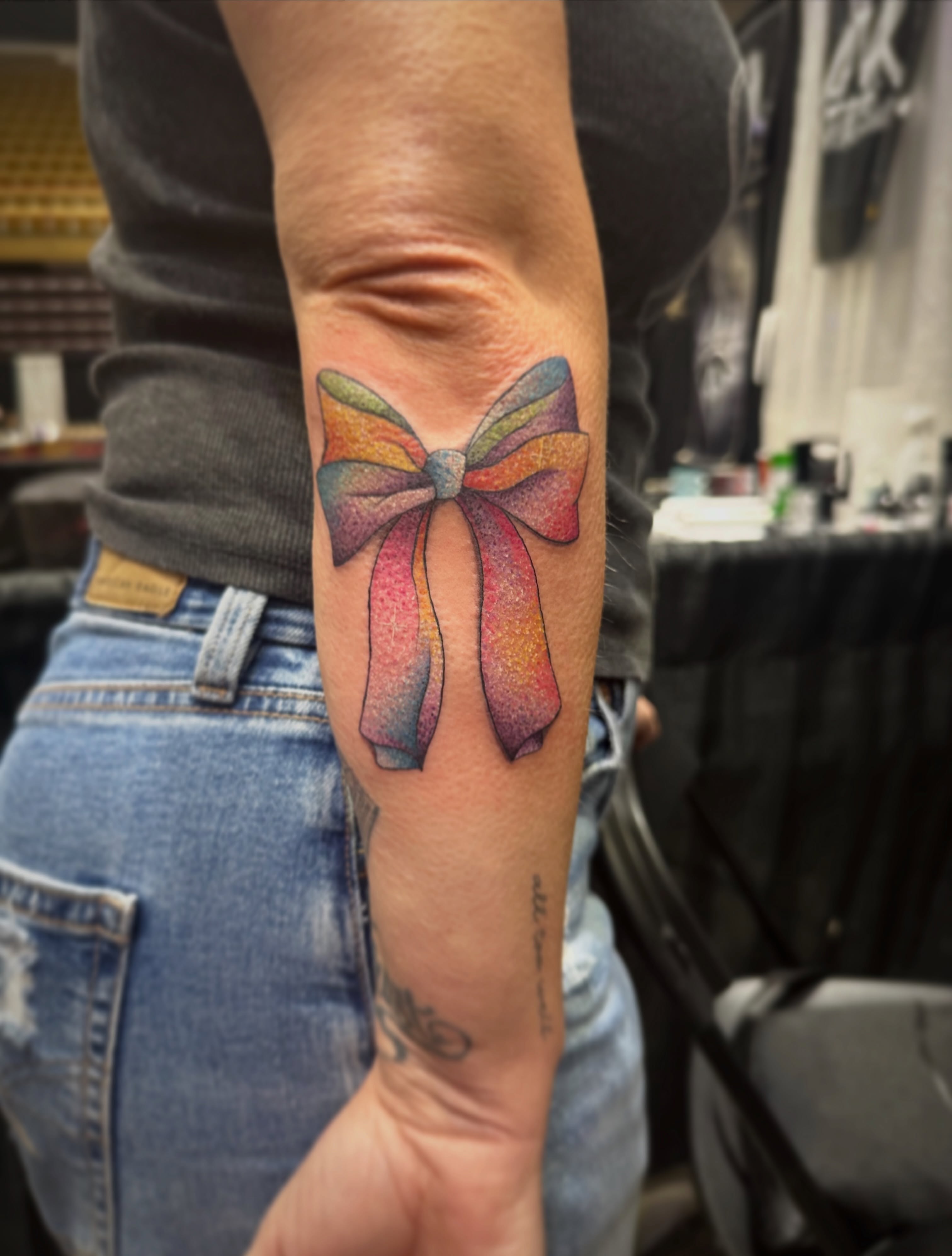 Bow dotwork tattoo on the forearm by Elizabeth’s Eclectic Tattoos