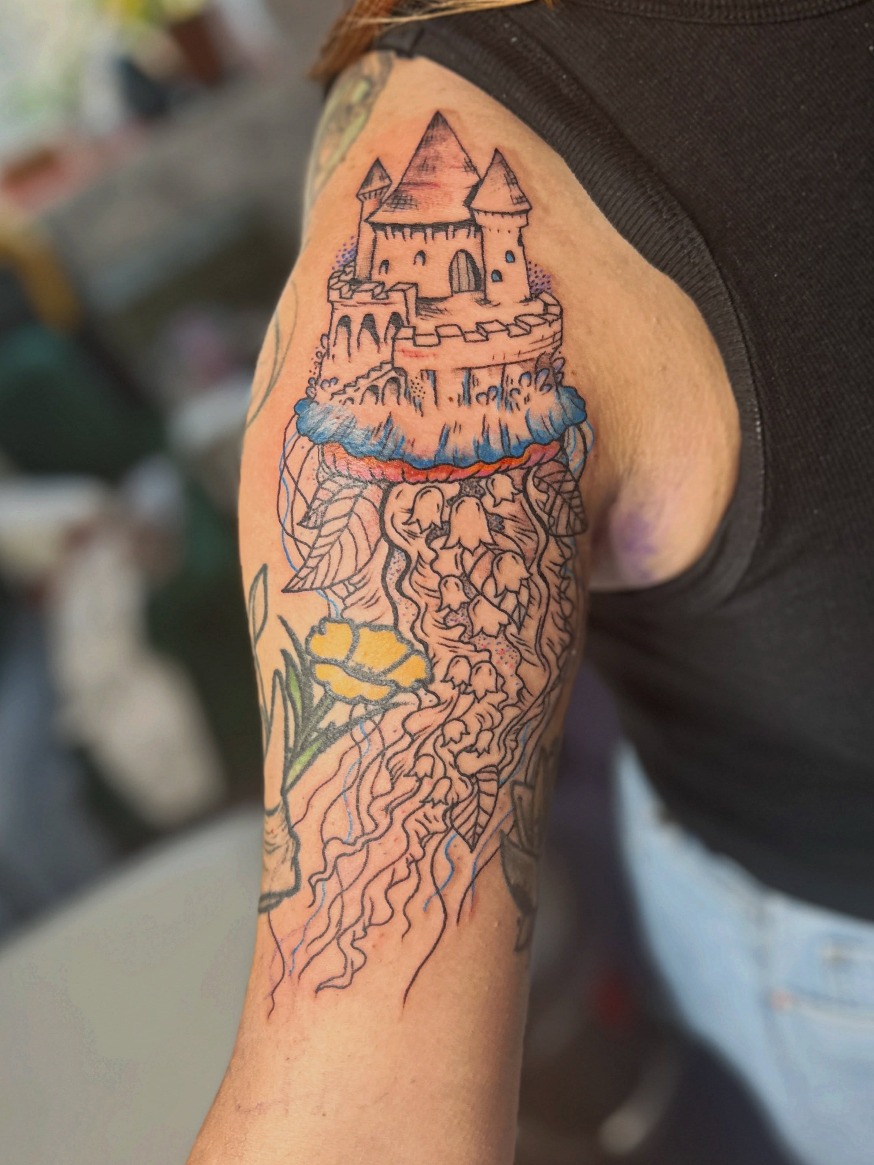Castle on cliff dotwork tattoo on the upper arm by Emma Berger