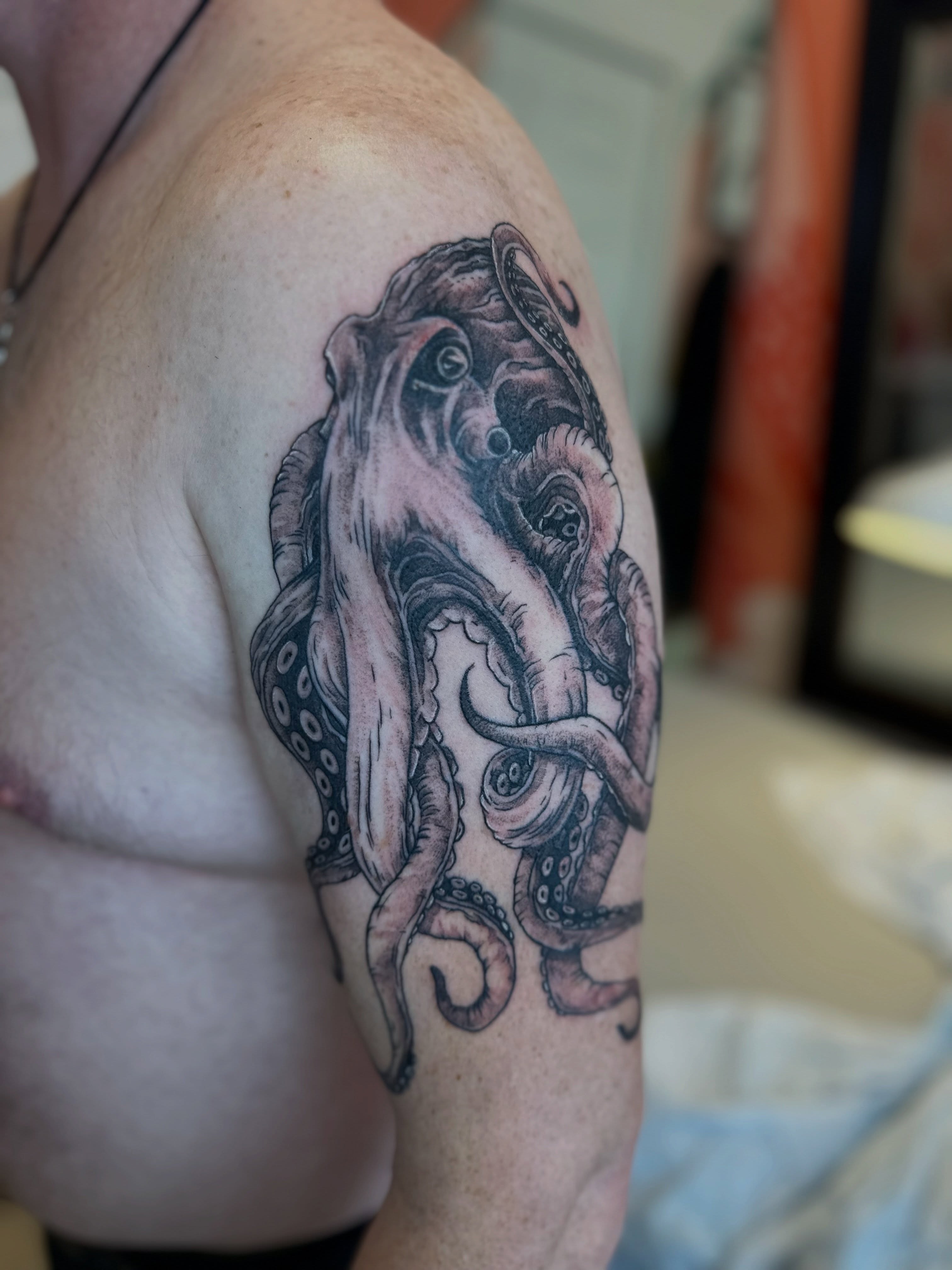 Octopus black and grey tattoo on the shoulder by Emma Berger