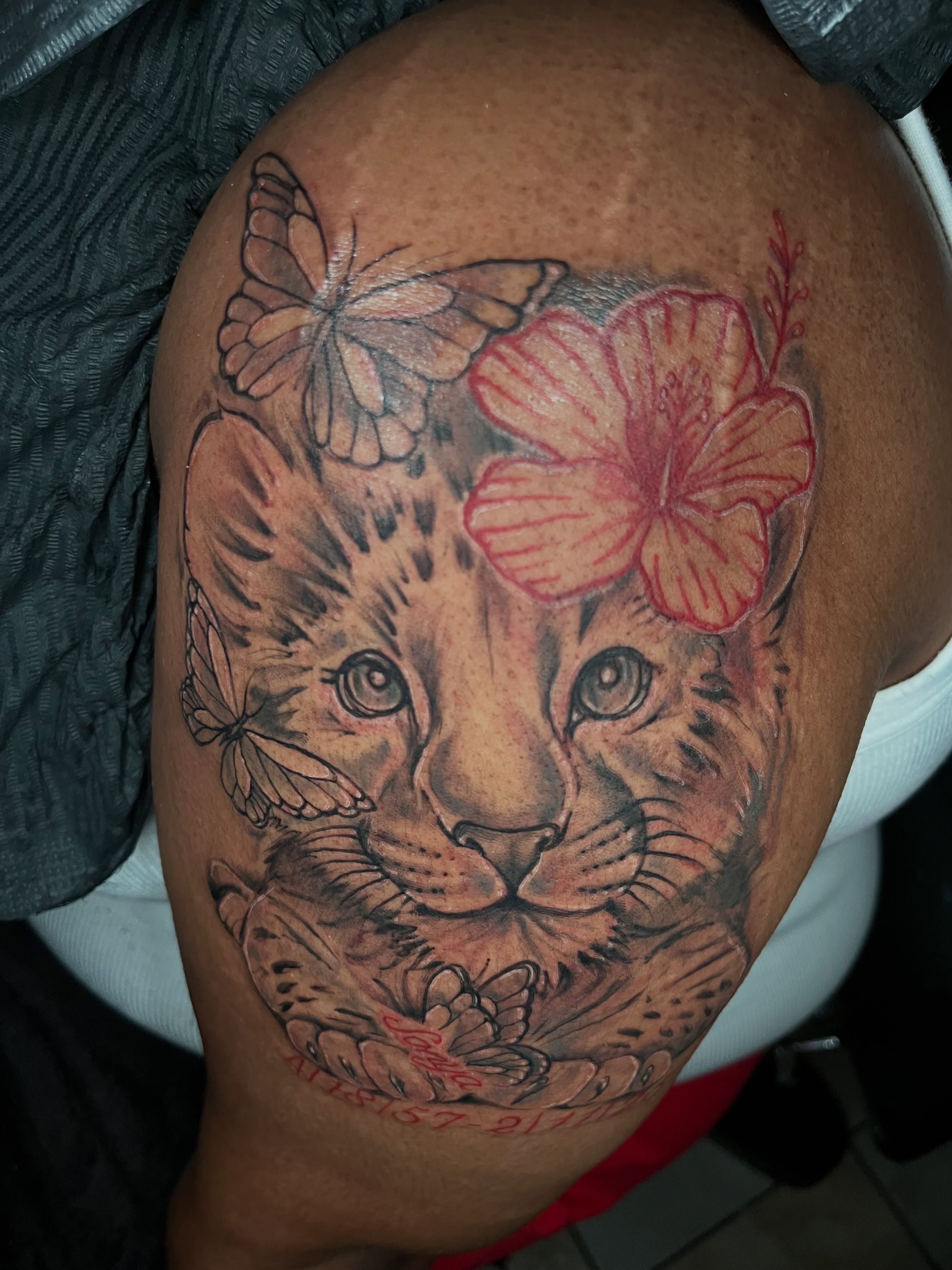 Leopard with flower realism tattoo on the shoulder by Jakobi
