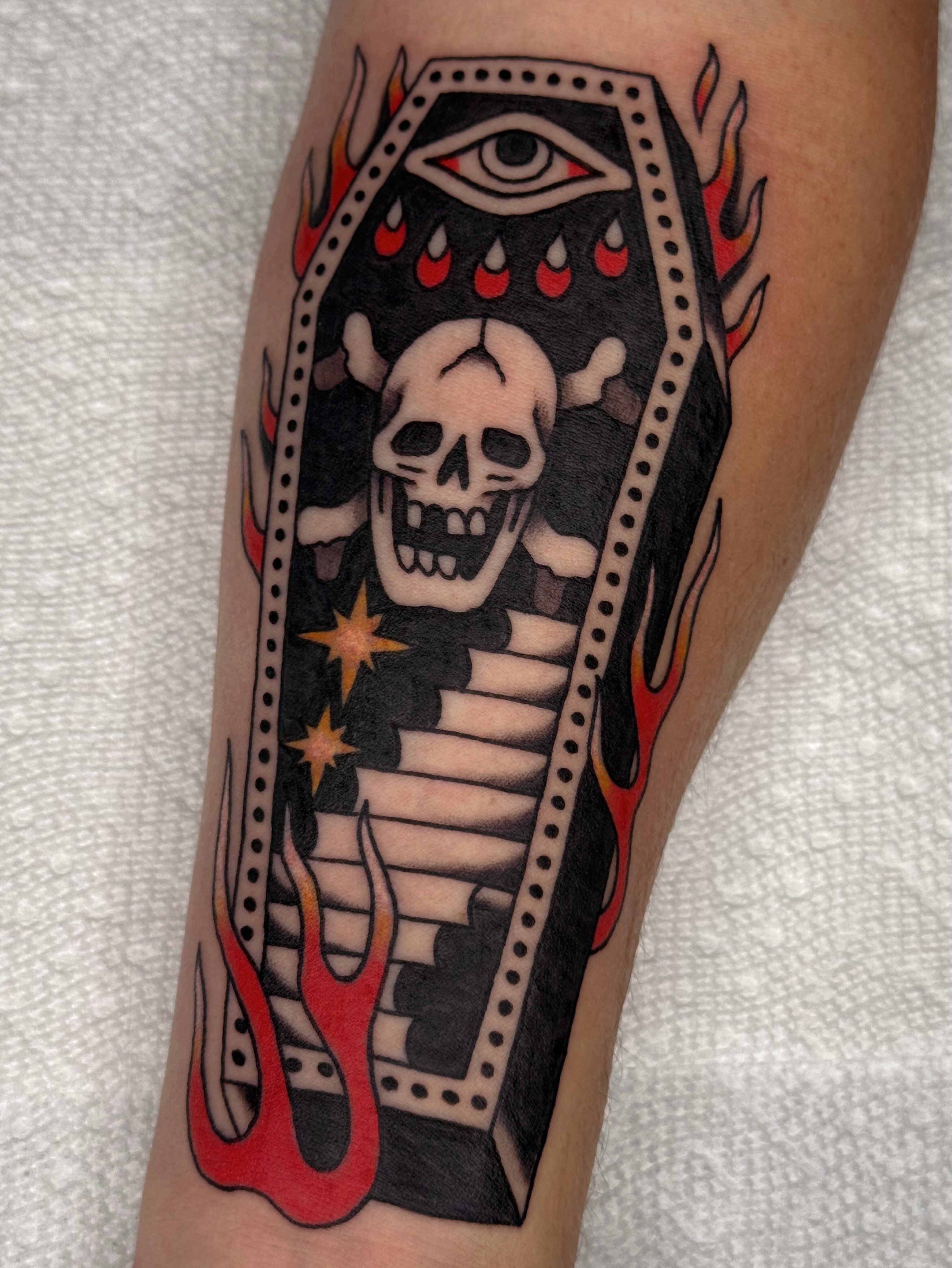 Coffin with skull American traditional tattoo on the forearm by Bridgette Carberry