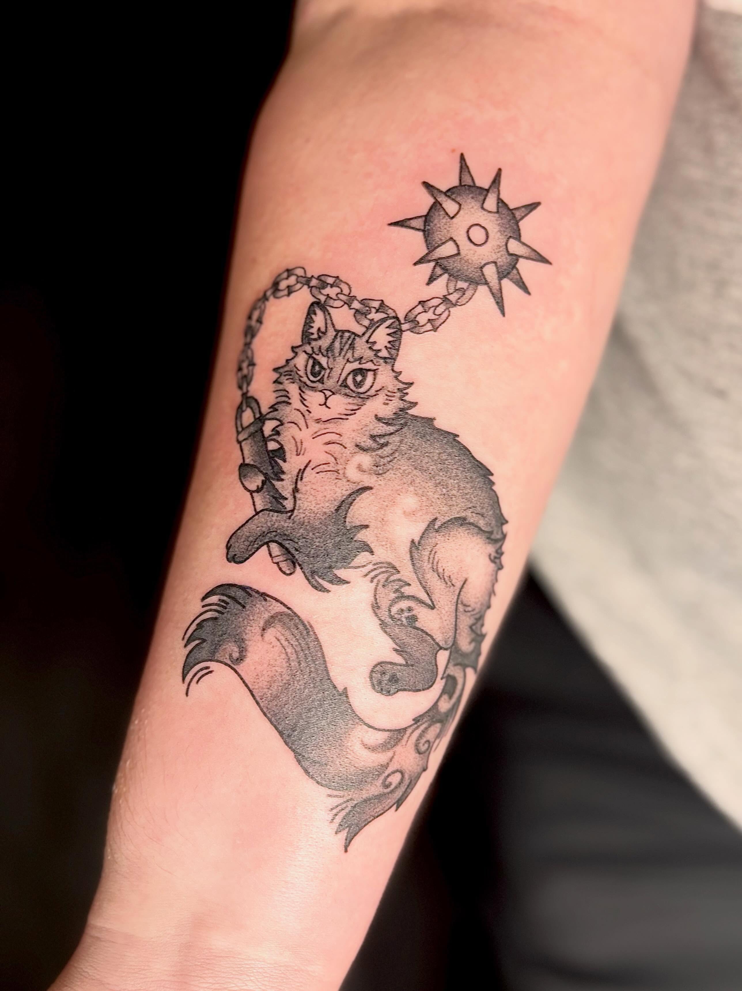 Cat and sun black and grey tattoo on the forearm by Erica McCullough