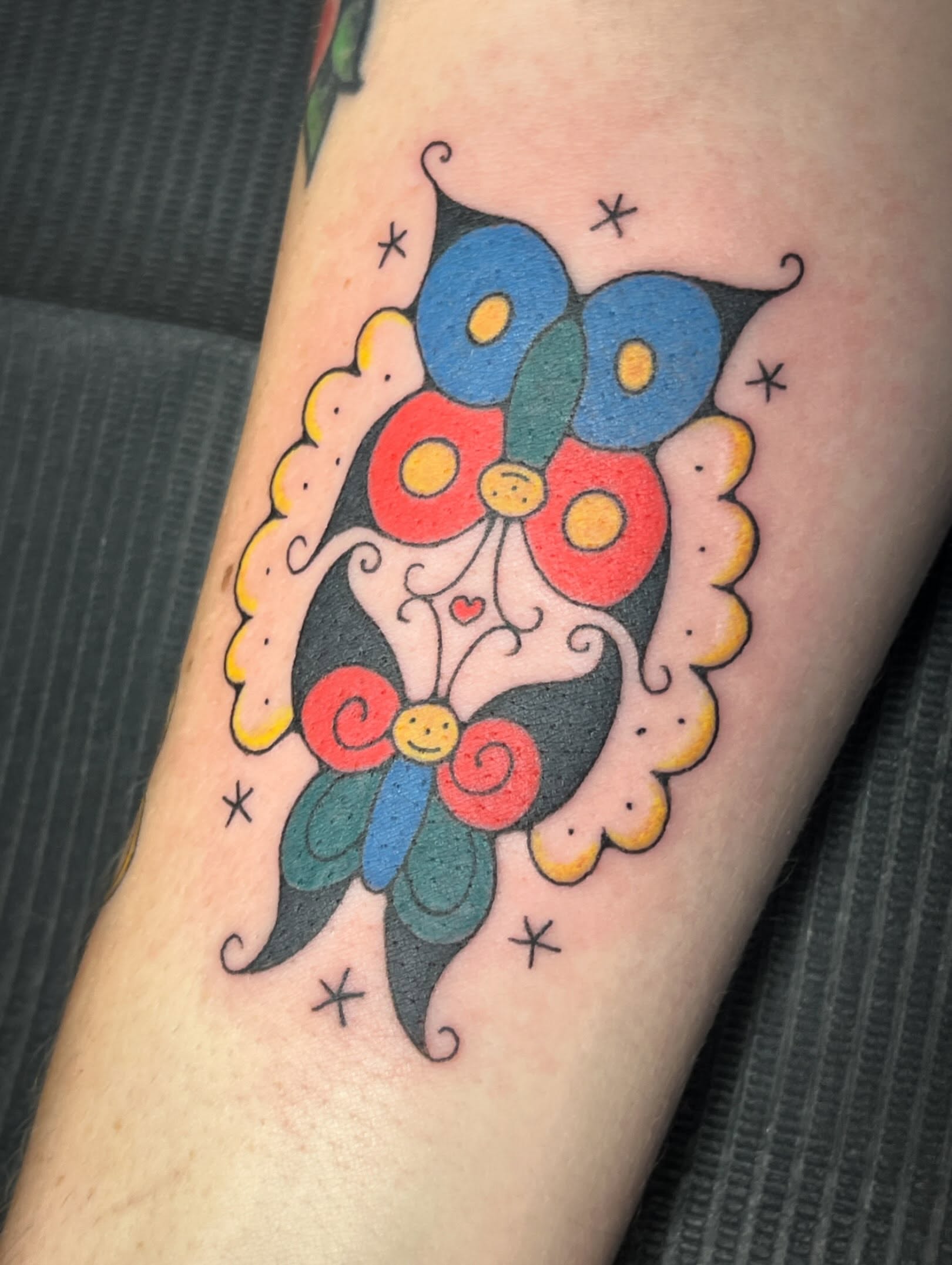 Butterfly American traditional tattoo on the forearm by Tattoo Kayla