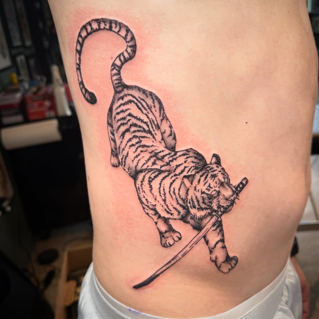 Tiger with sword realism tattoo on the ribs by Luisa Gonzalez, Austin, Texas