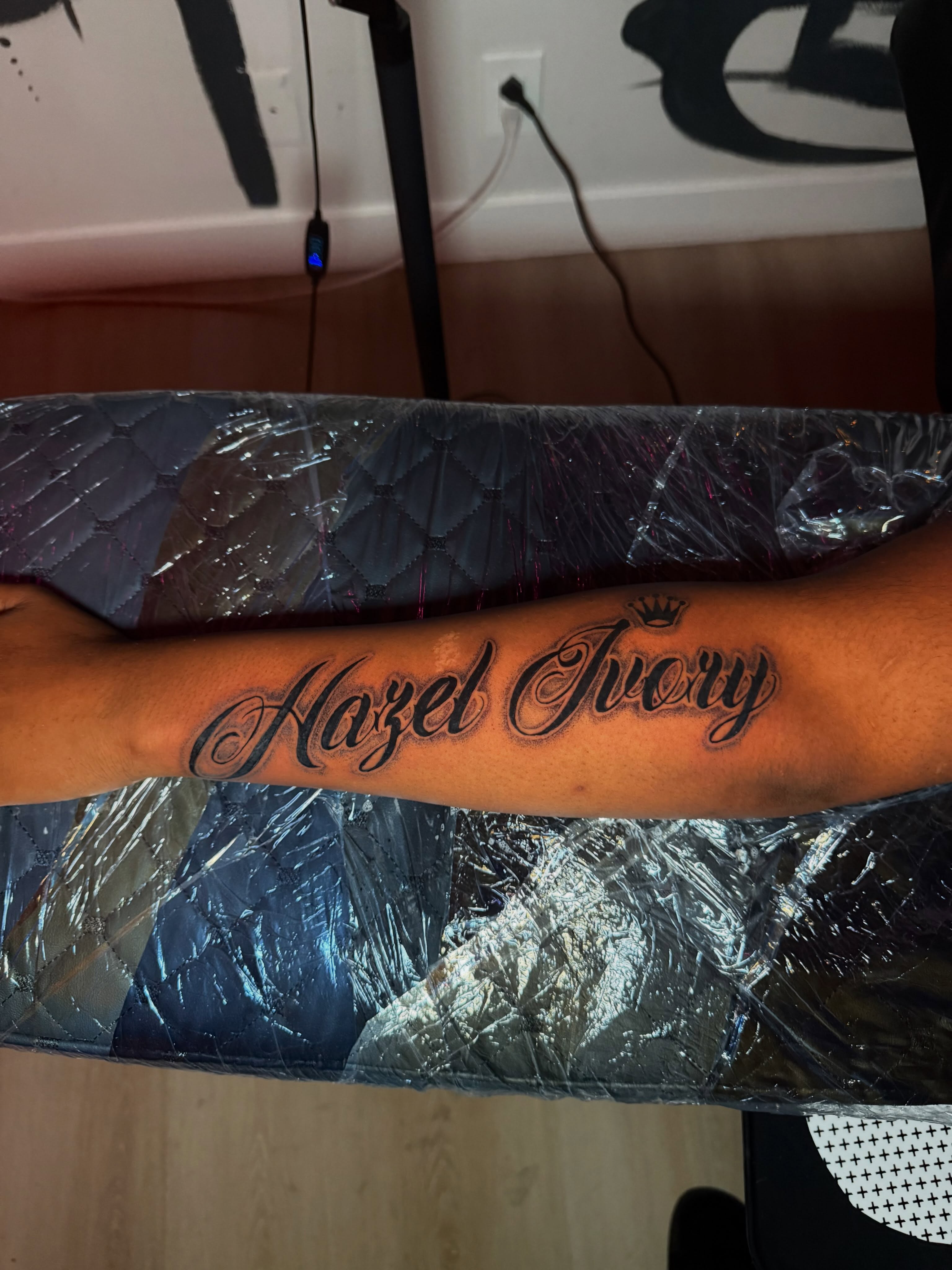 Hazel Ivory lettering script tattoo on the forearm by Kelsoink