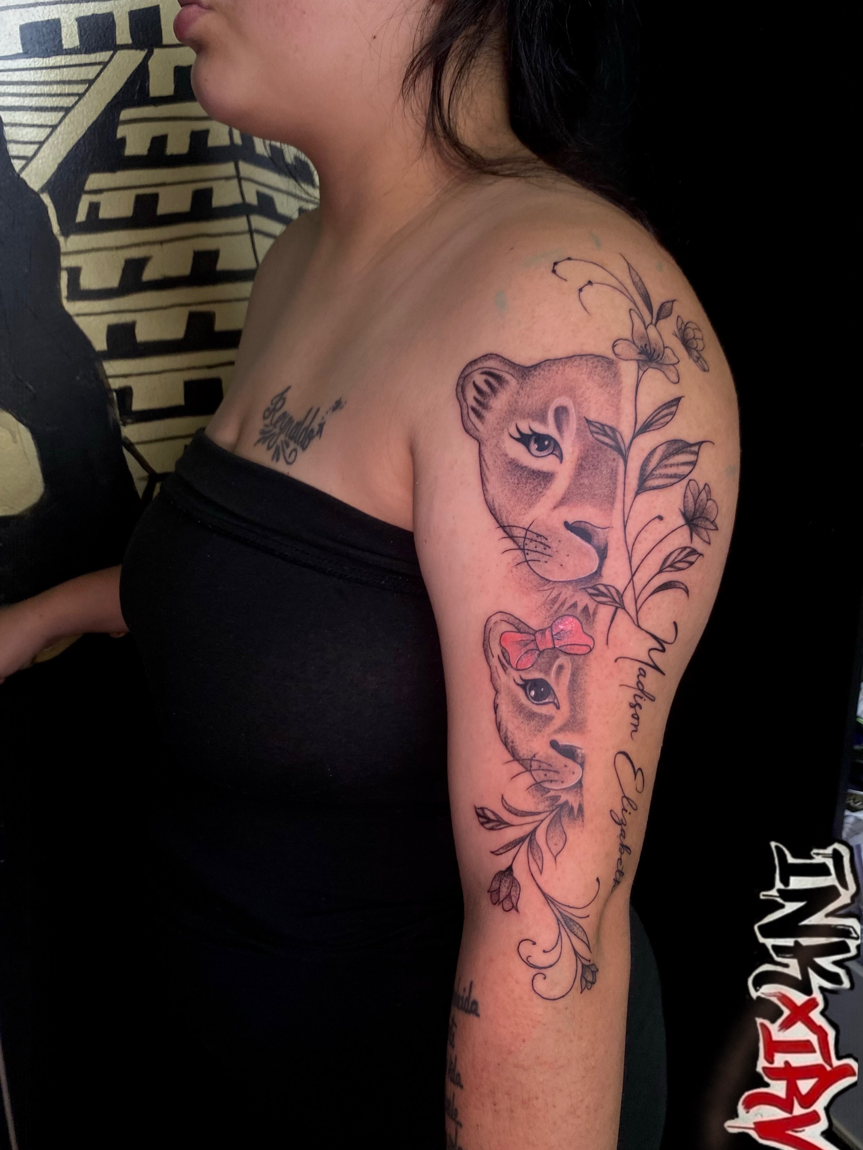 Lioness and cub realism tattoo on the upper arm by Irving Guzman