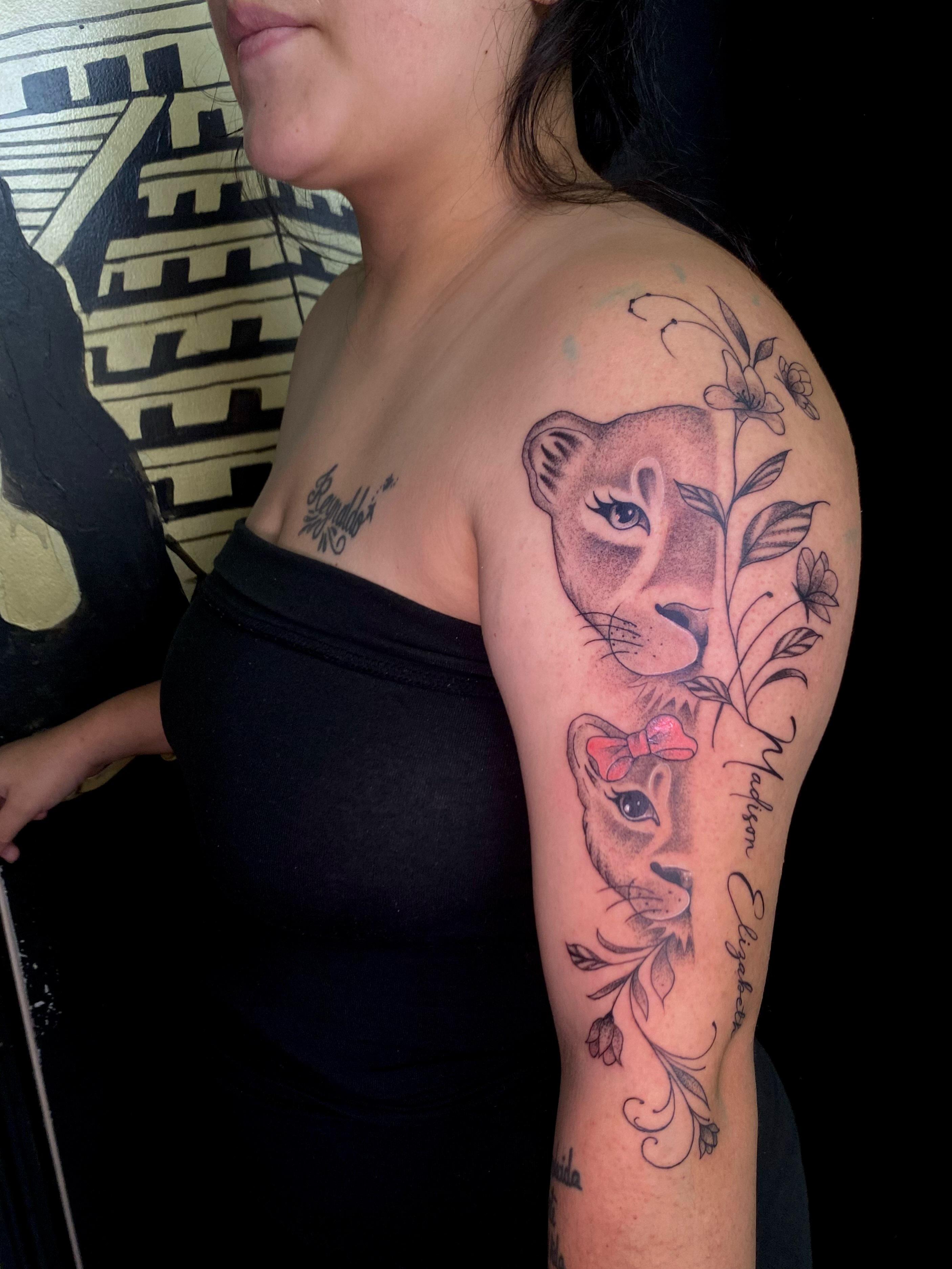 Lioness and cub realism tattoo on the upper arm by Irving Guzman
