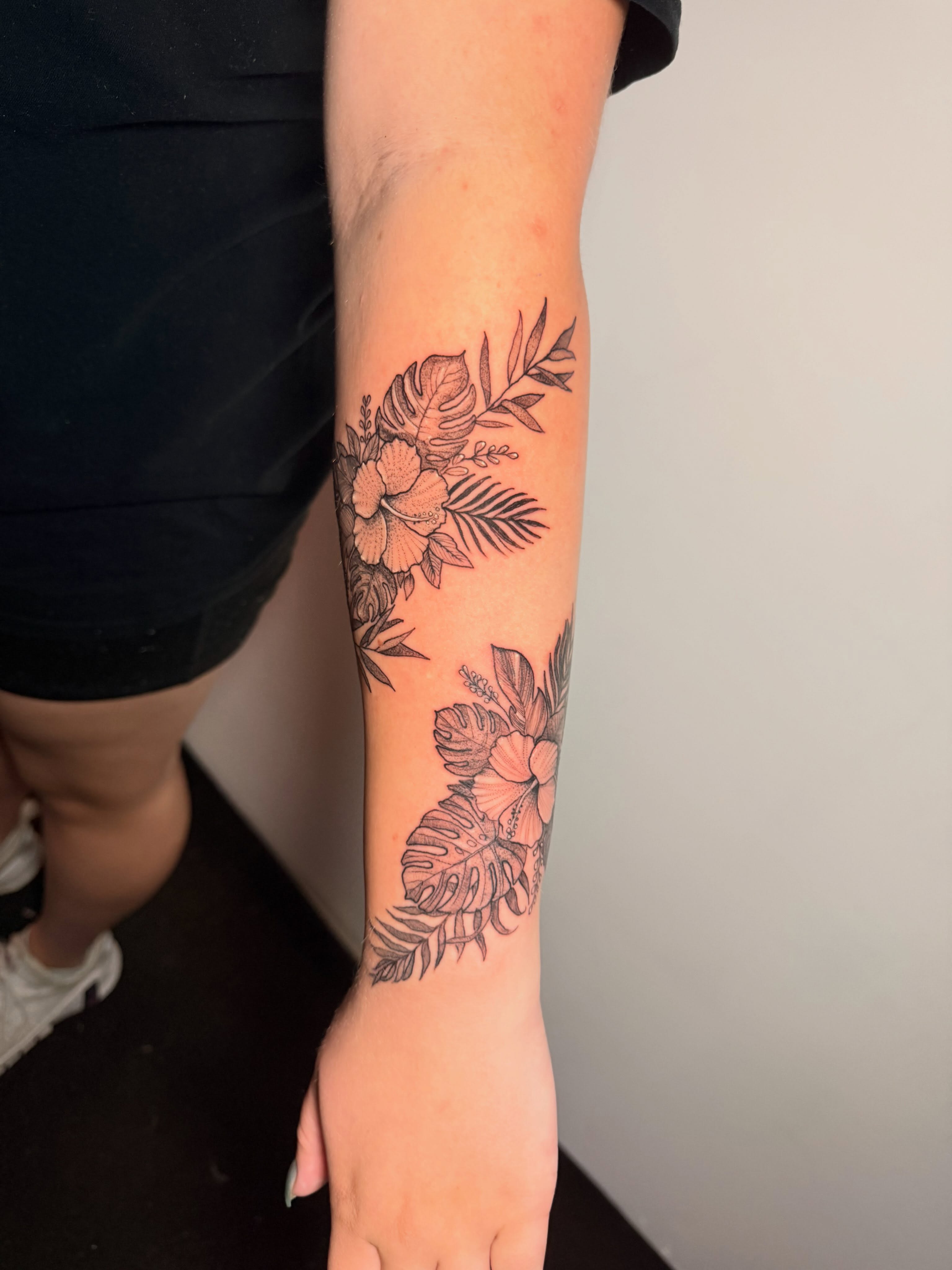 Floral arrangement black and grey tattoo on the forearm by Gabrielle Frelak, York, Pennsylvania